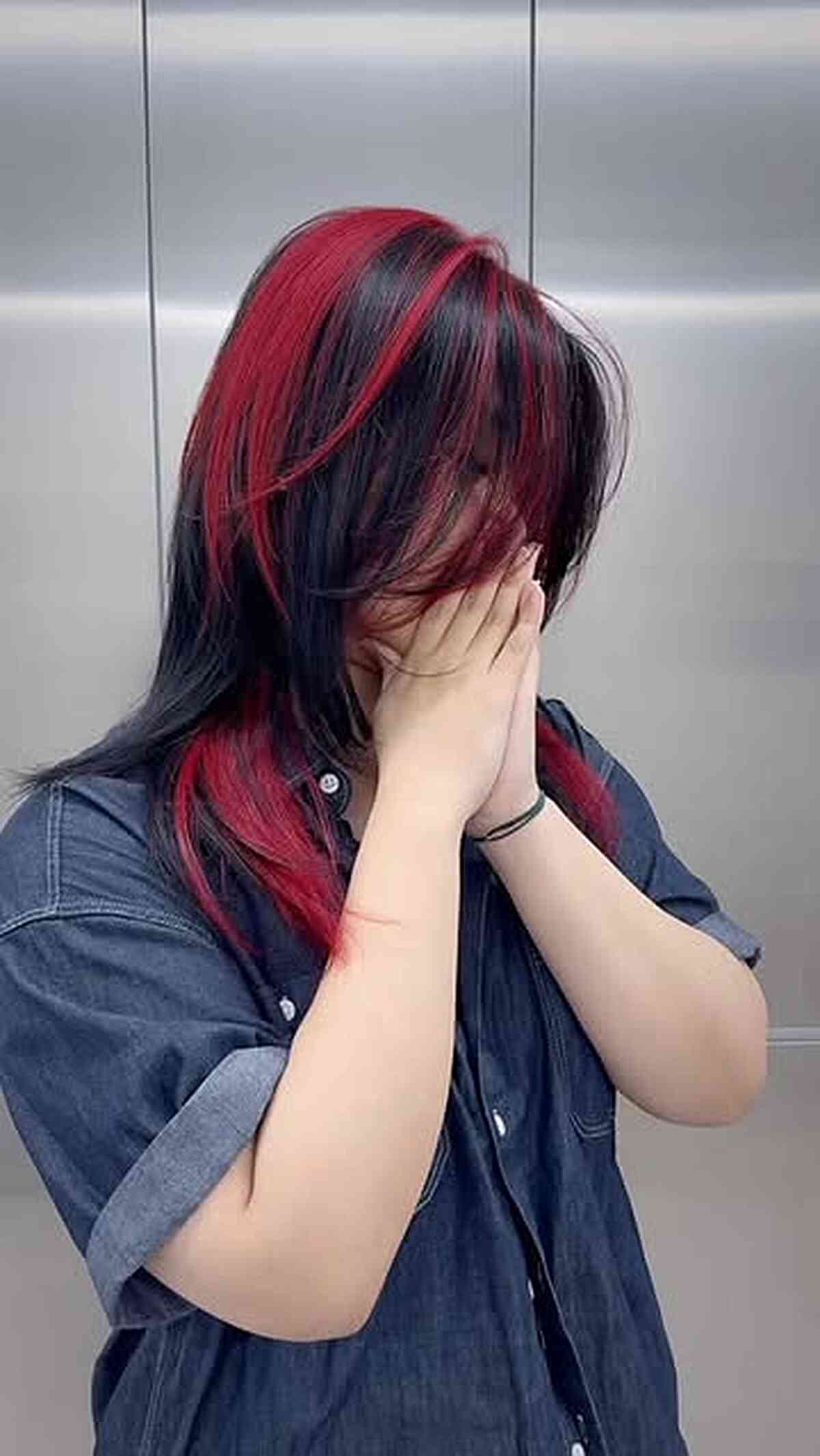 Bold Red and Black Hair with Face-Framing Highlights
