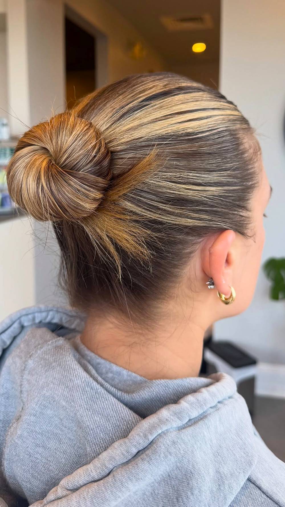 Sleek Low Bun with Subtle Caramel Highlights