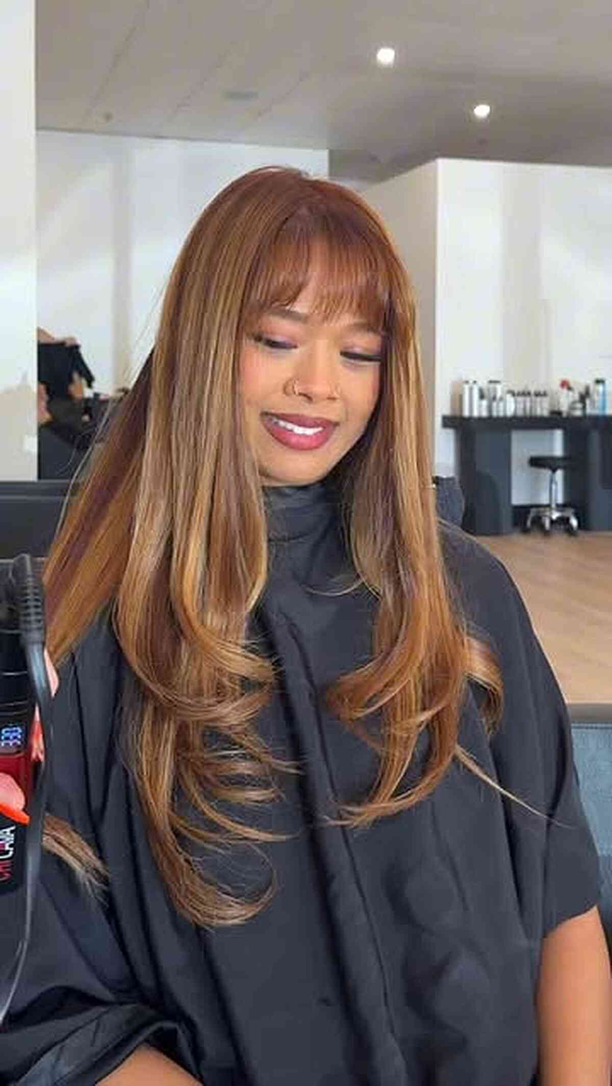 Light Caramel Layered Haircut with Wispy Bangs