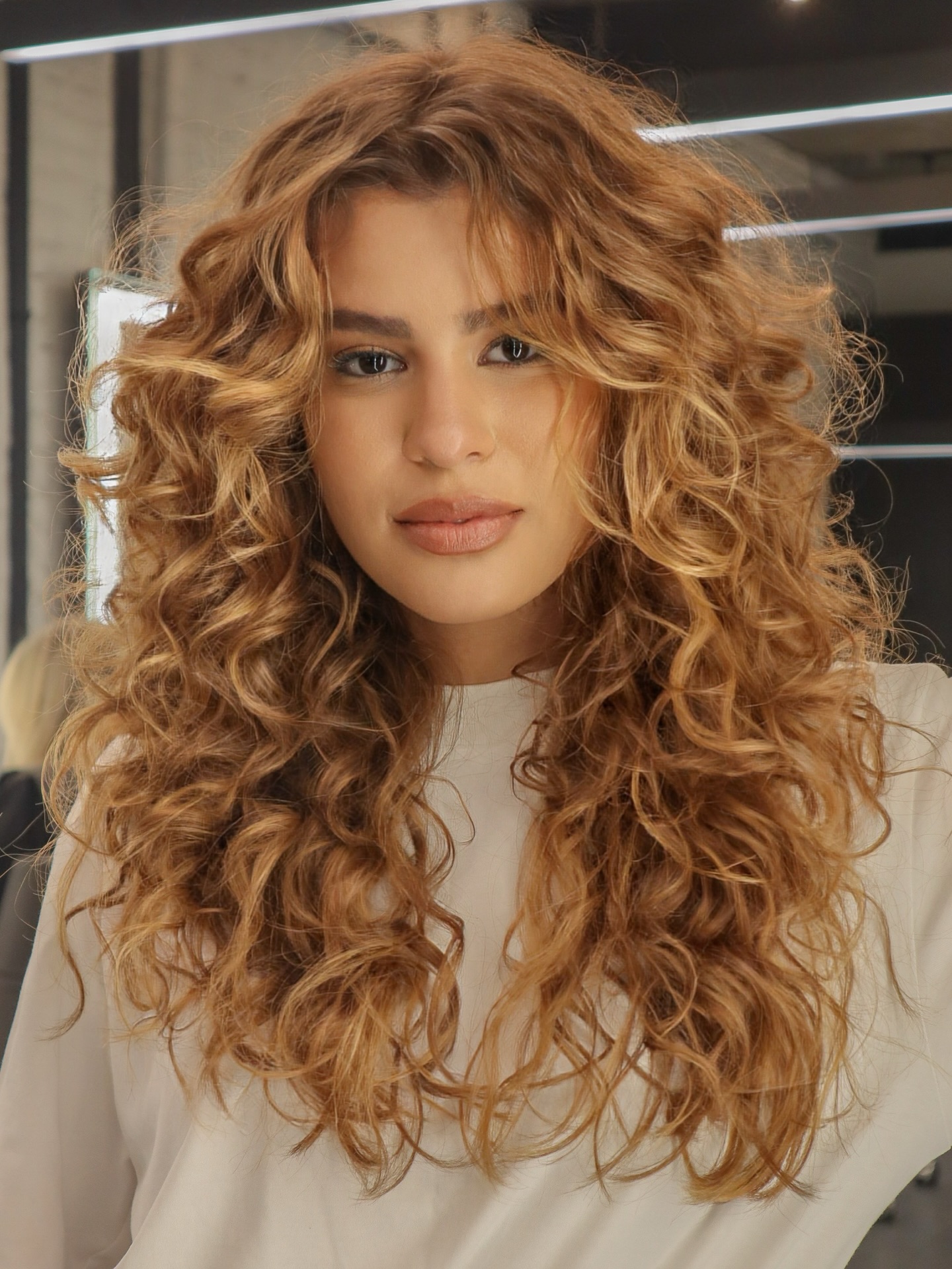 Cascading Golden-Caramel Ringlets with Blended Highlights