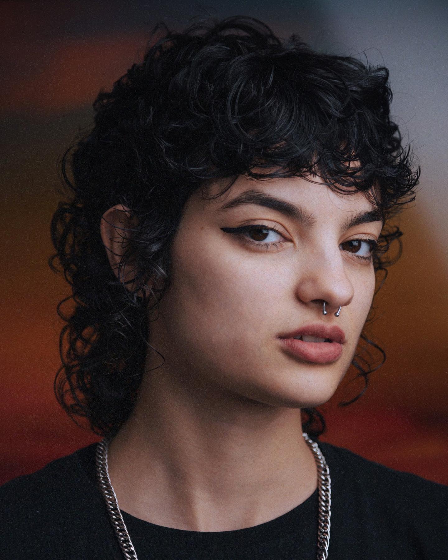 Edgy Black Curly Wolf Cut with Disheveled Bangs