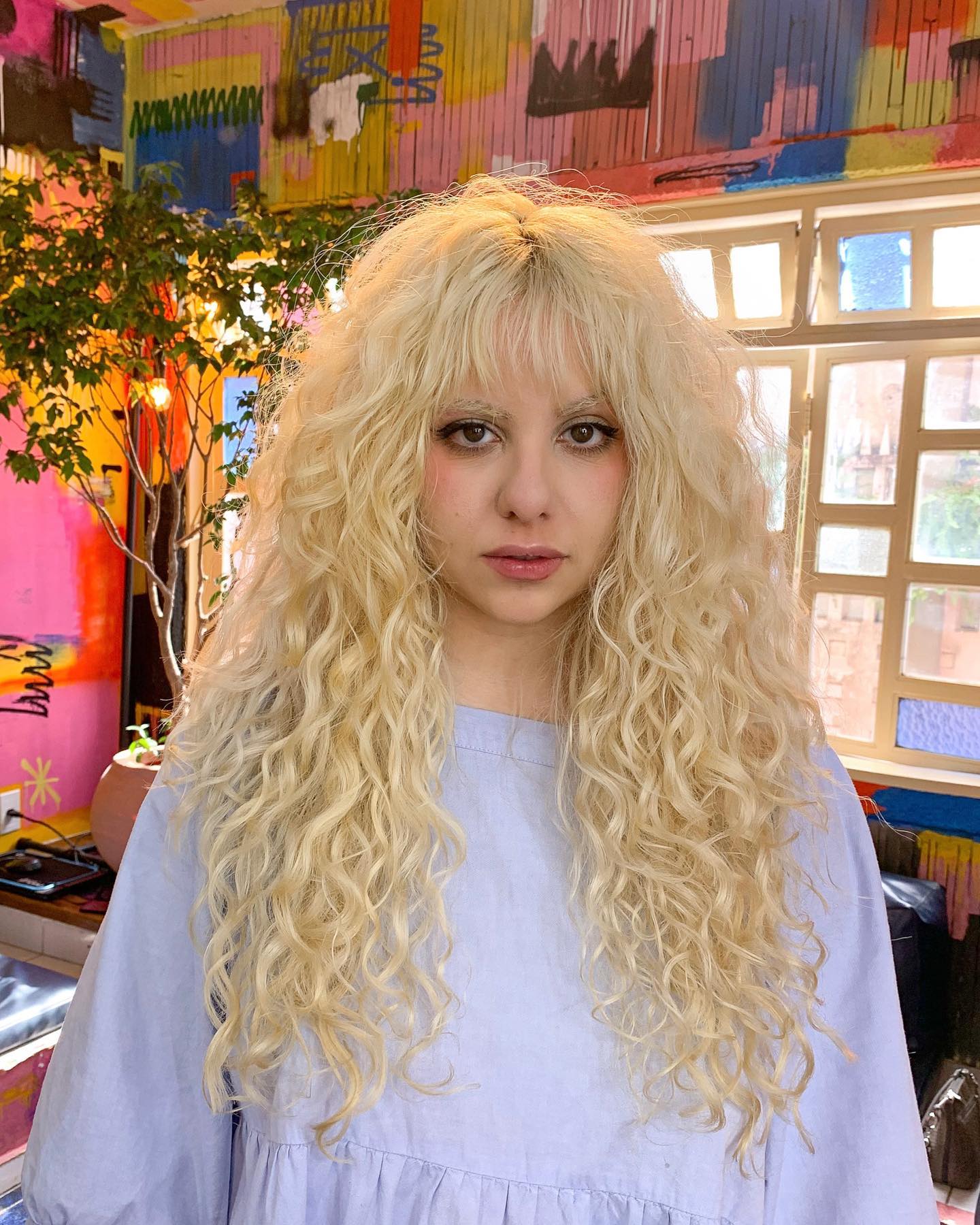 Luxurious Platinum Blonde Curly Shag with Soft Fringe