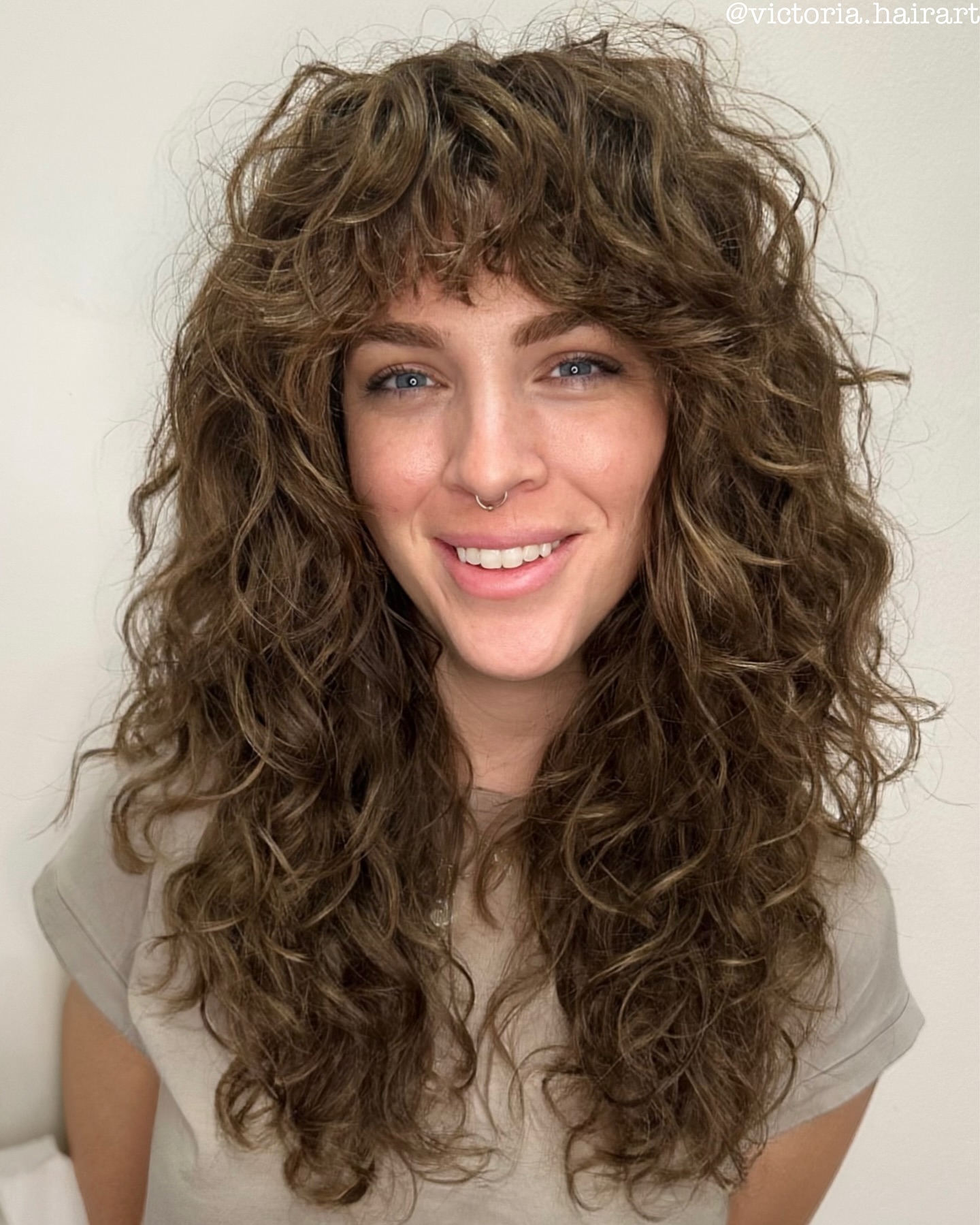 Naturally Tousled Chestnut Curls with Bangs
