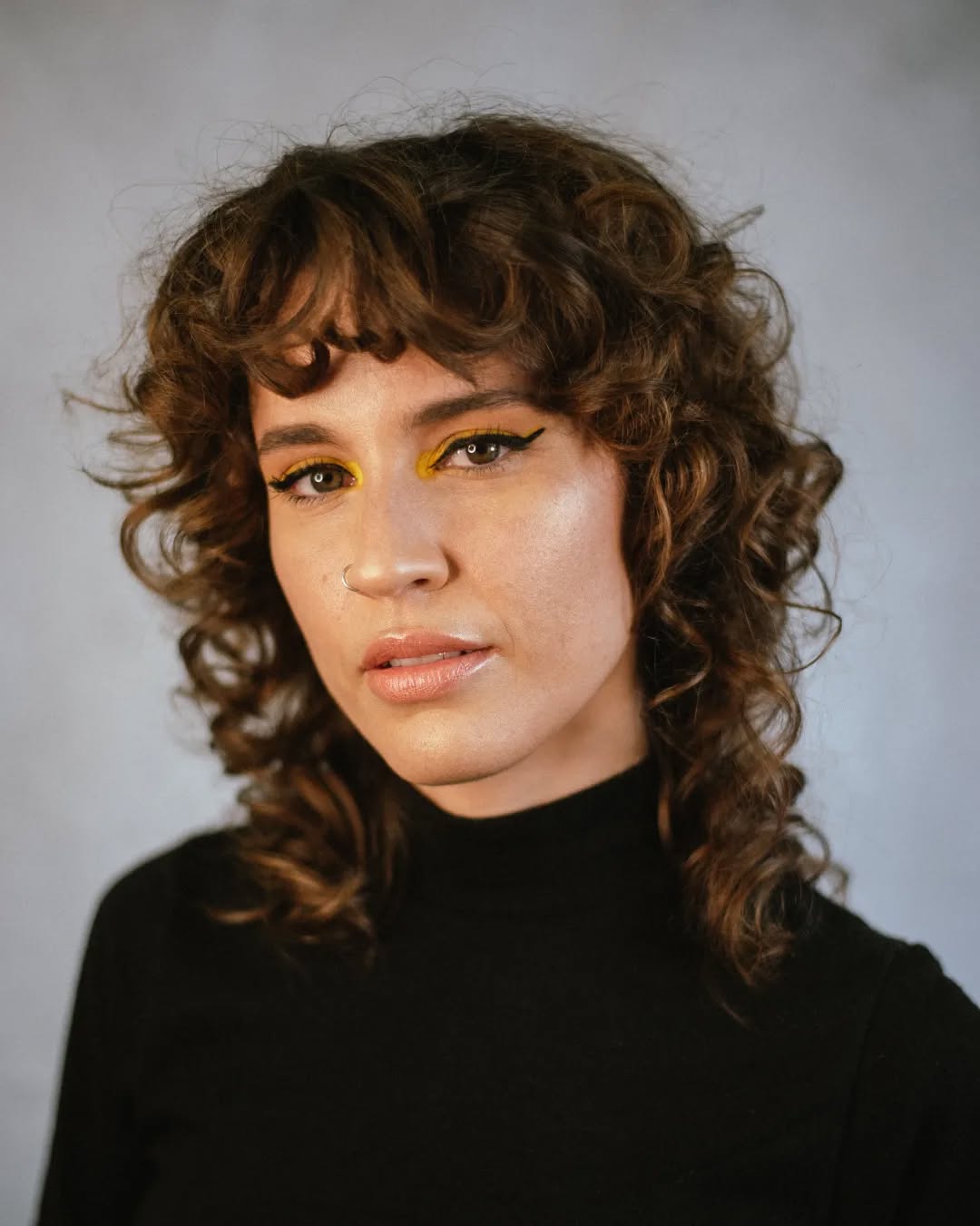 Subtle Chestnut Curly Wolf Cut with Artistic Flair