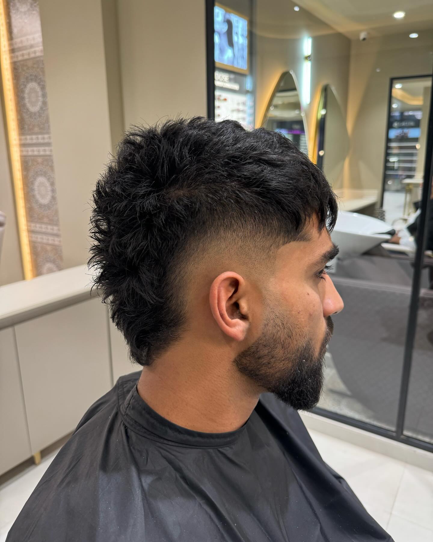 Textured Black Tousled Mohawk with Natural Waves