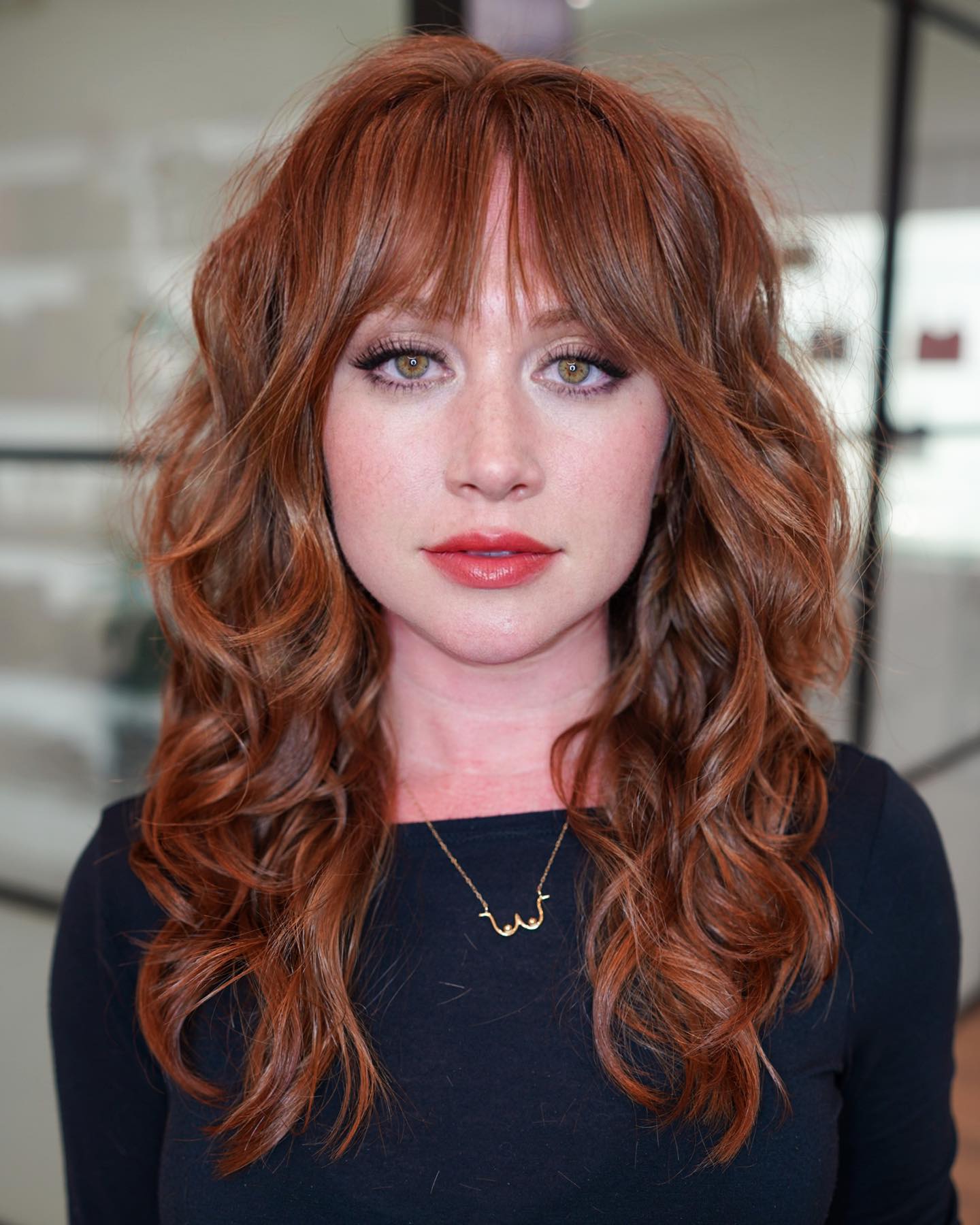 Vibrant Copper Tousled Curls with Face-Framing Bangs