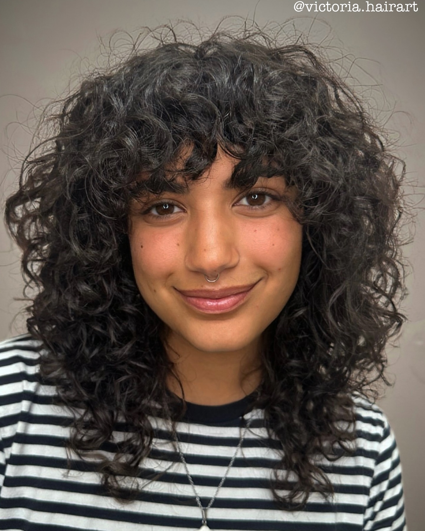 Voluminous Medium-Length Curly Shag with Bangs