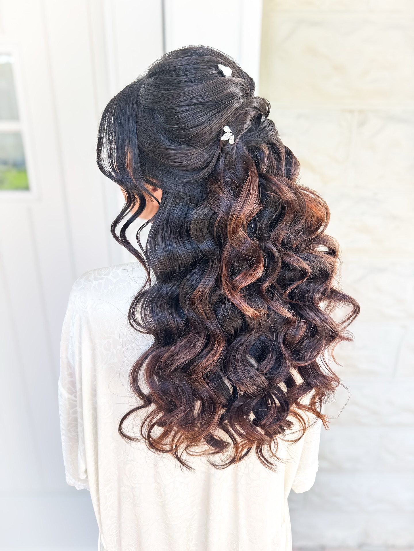 Elegant Cascading Curls with Floral Pins