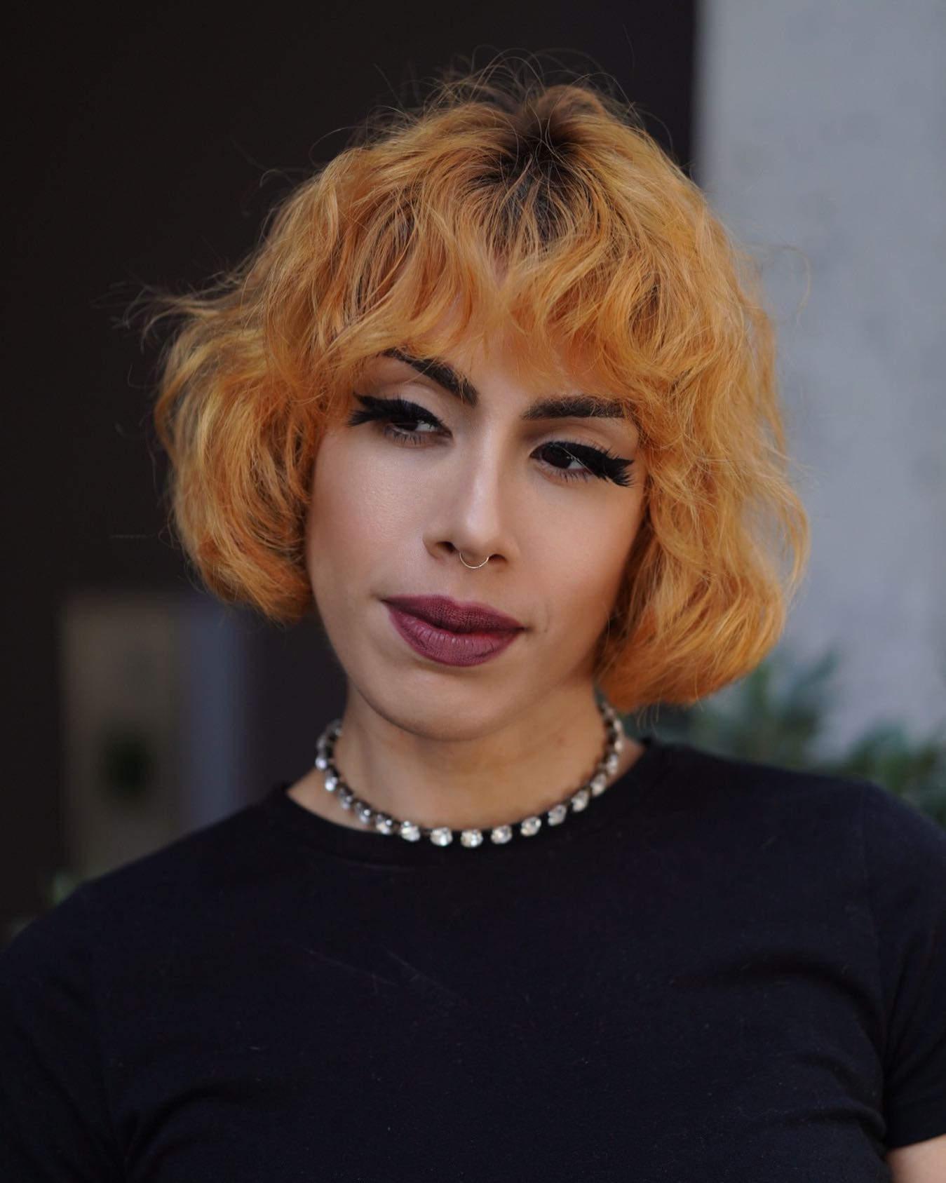 Bright Golden Curly Bob with Bold Bangs