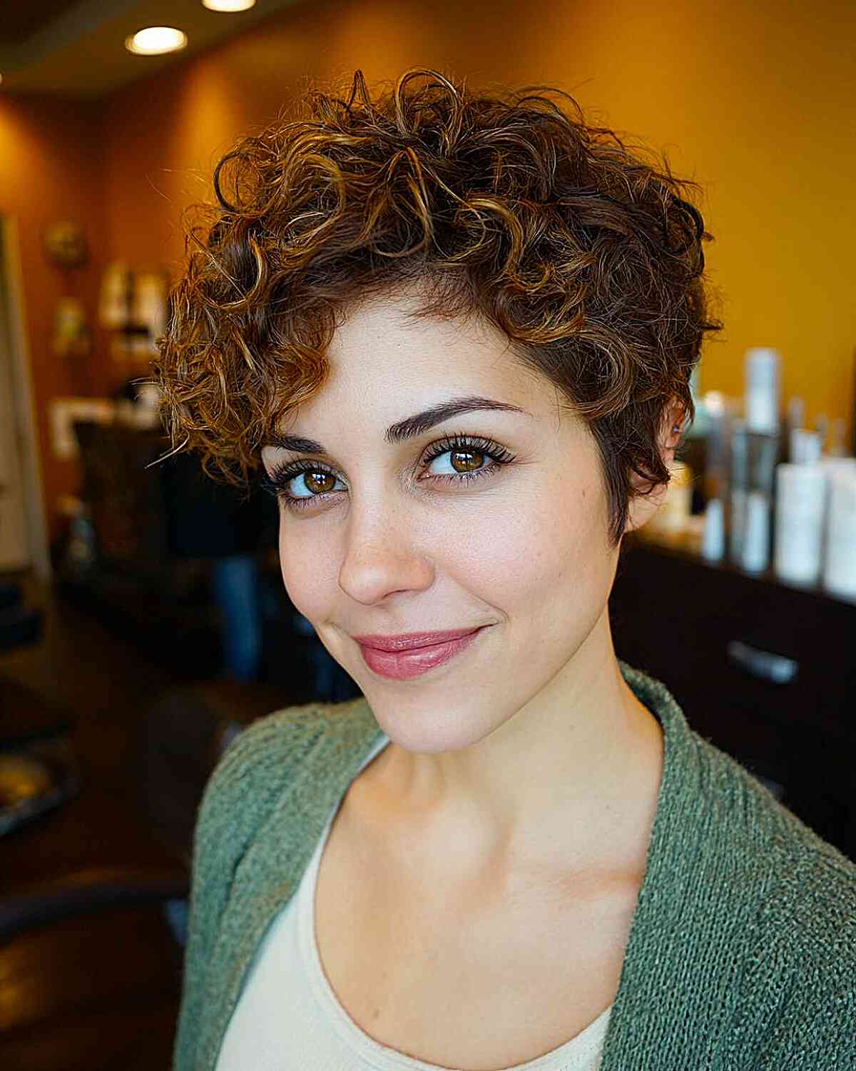 Textured Curly Pixie Cut with Warm Highlights