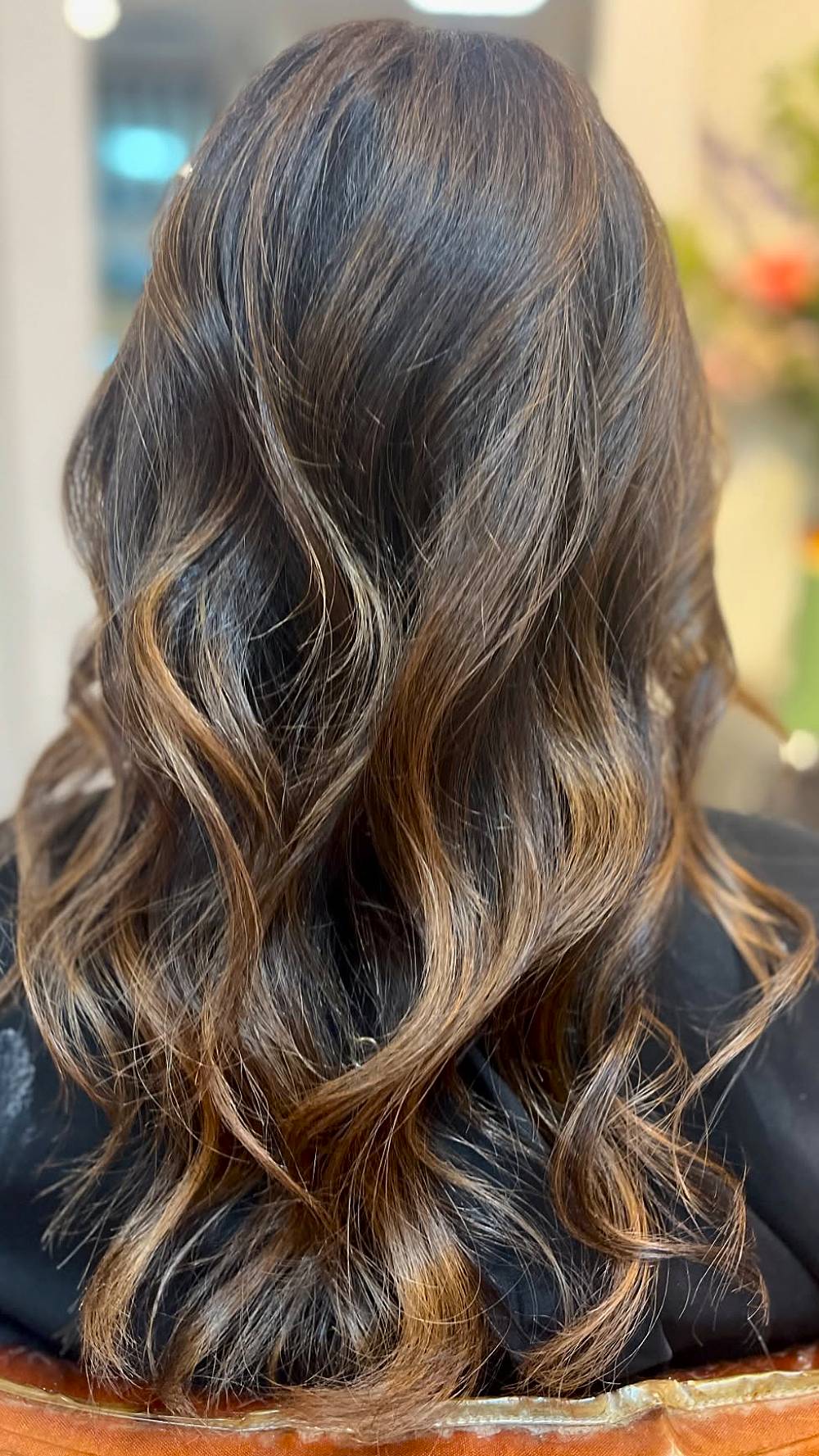 Chic Brunette Waves with Golden Highlights