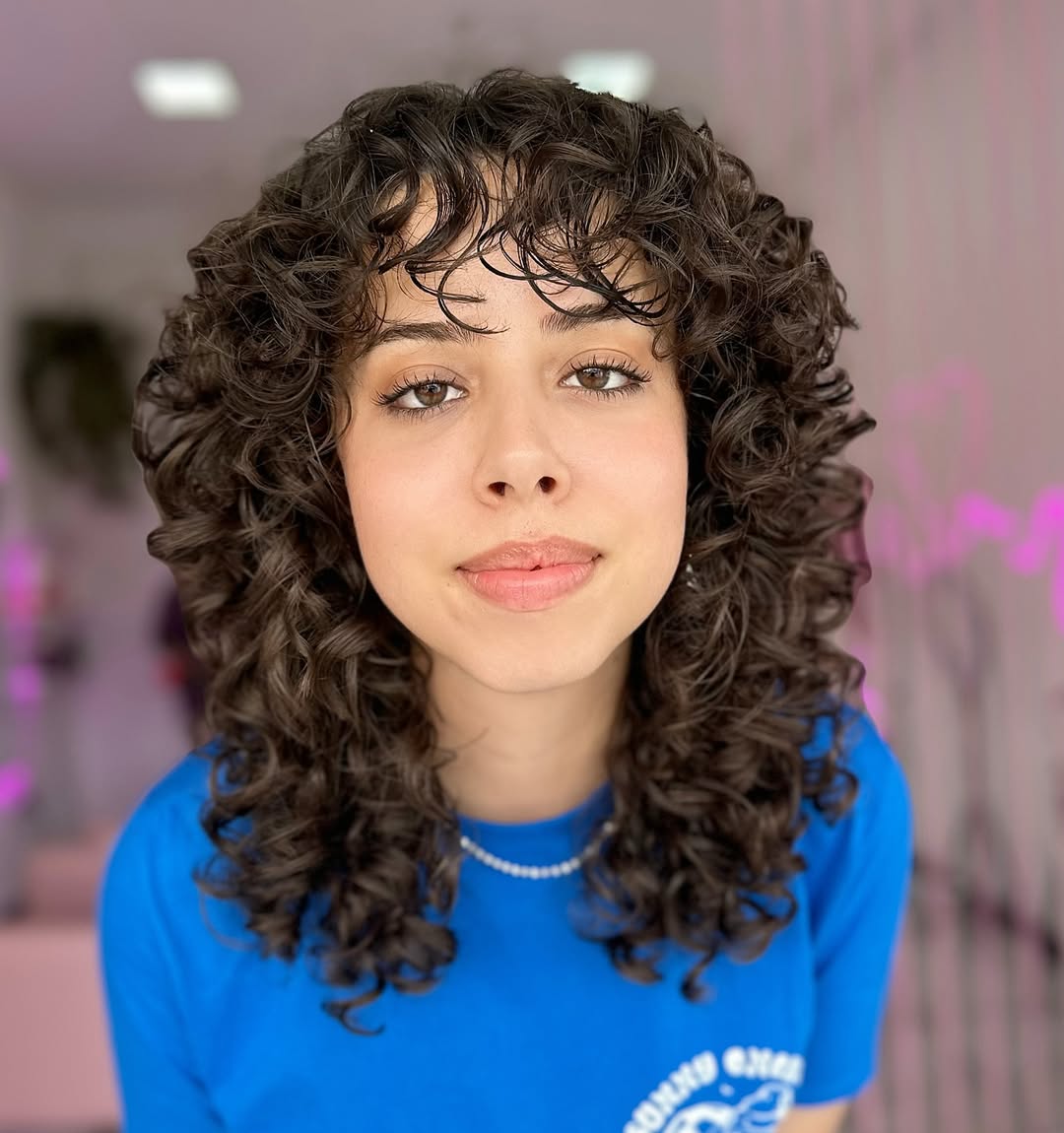Playful Medium-Length Curly Shag with Soft Bangs