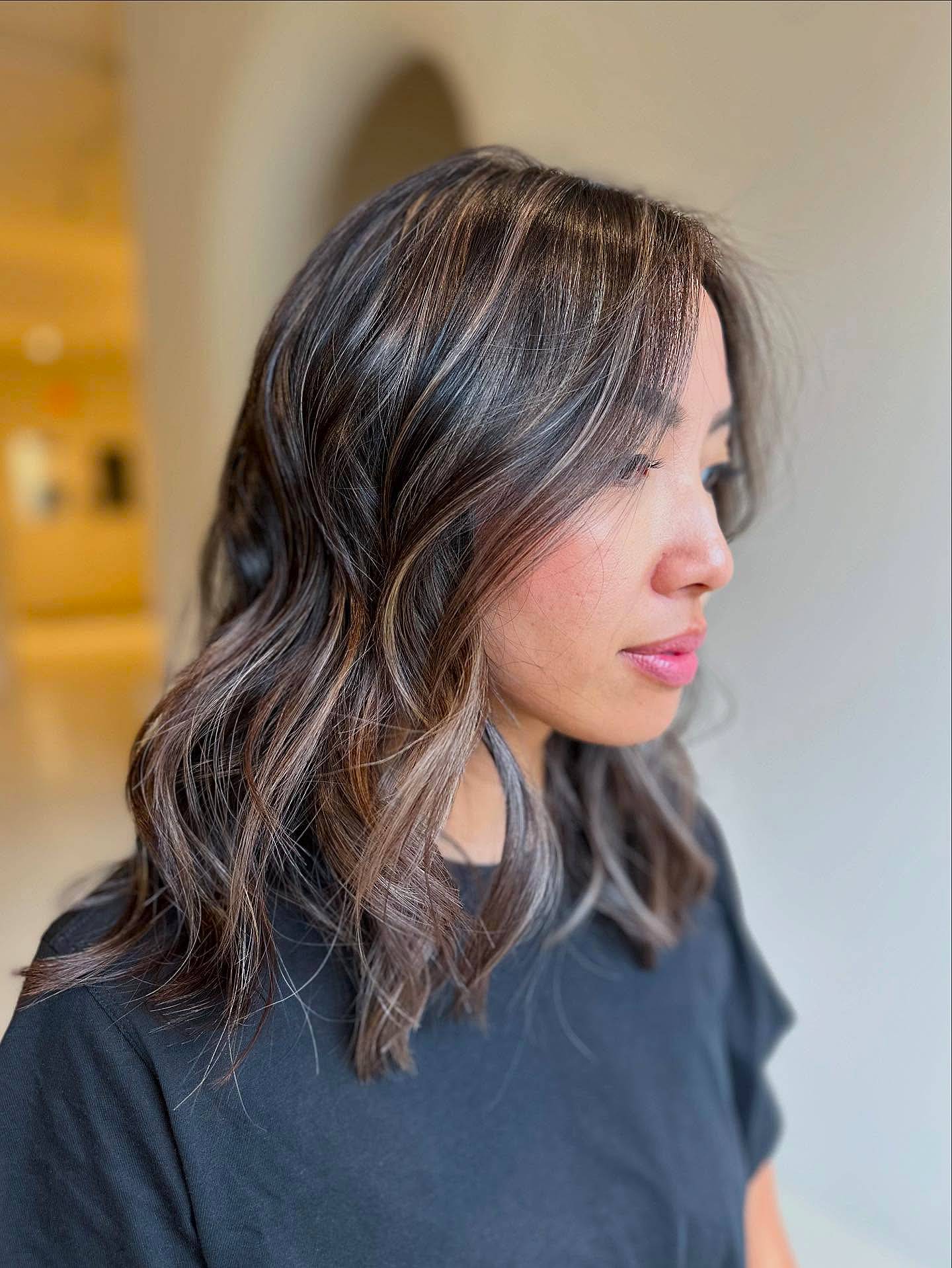 Softly Layered Medium Length Wavy Cut with Subtle Highlights