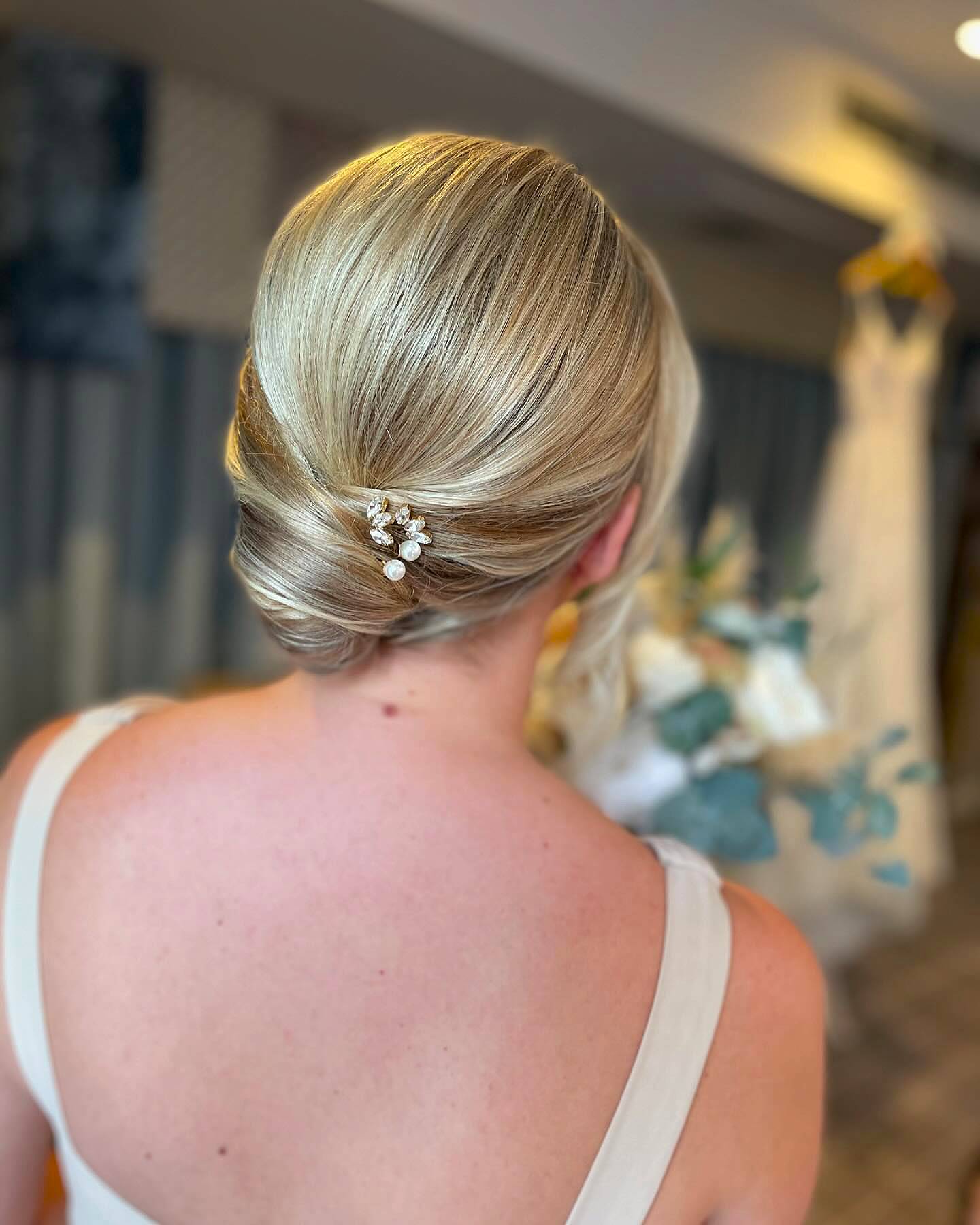 Elegant Twisted Low Bun with Floral Accent