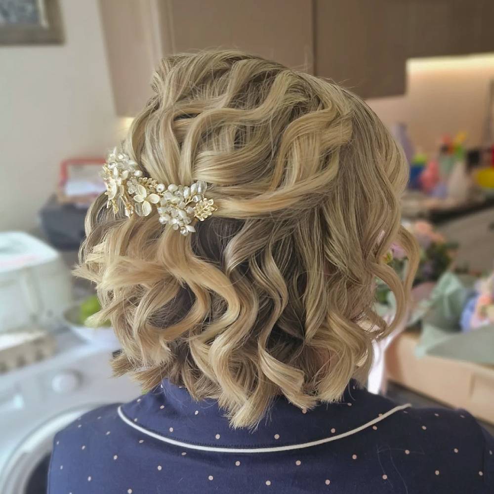 Romantic Curly Half-Up Style with Floral Accent