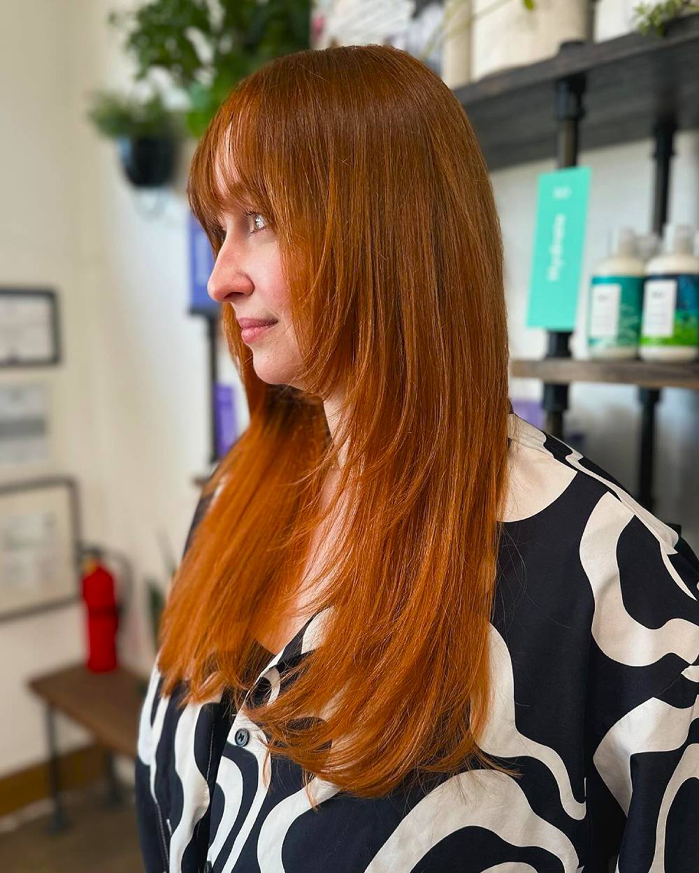 Sleek Long Ginger Layers with Subtle Face-Framing Bangs