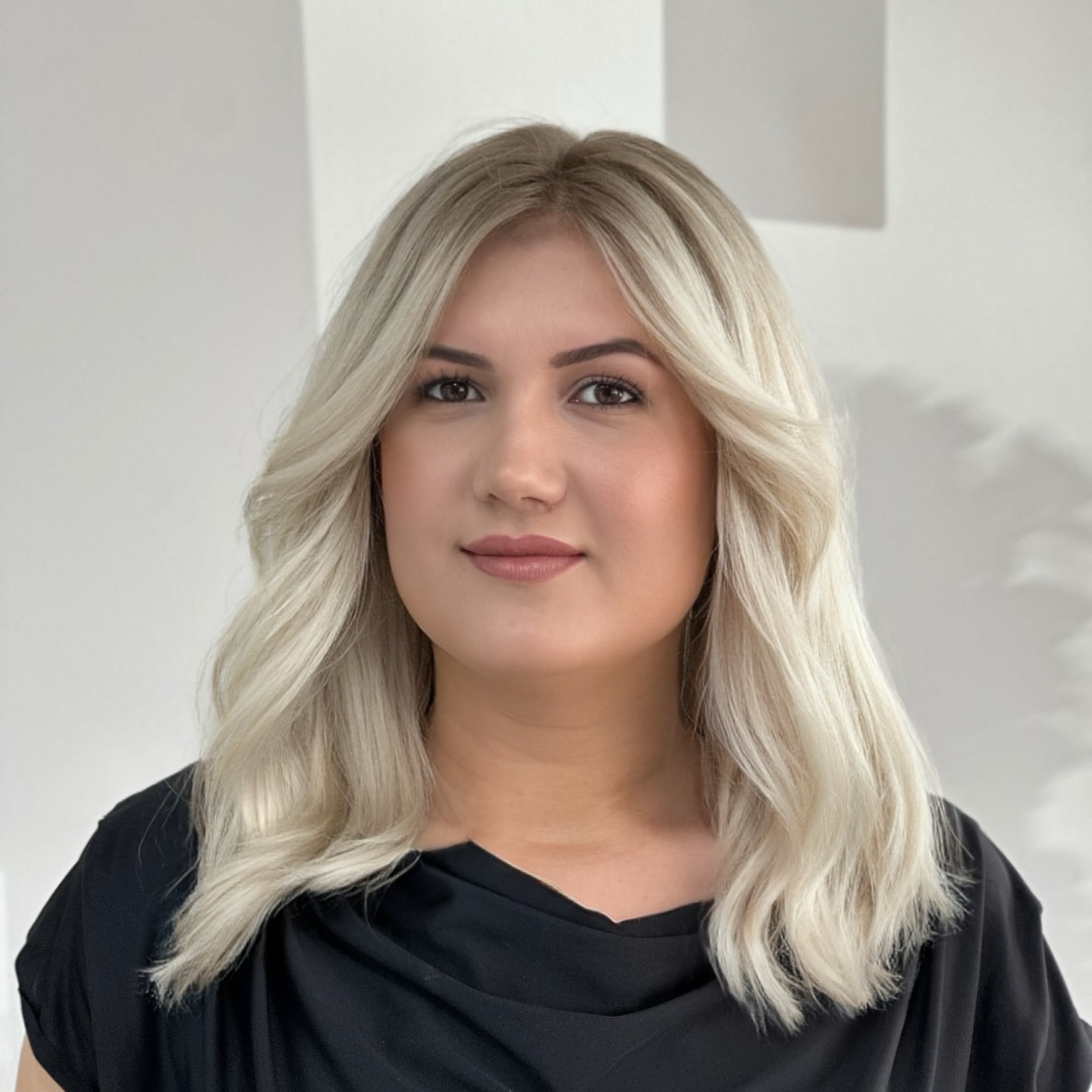 Sanfte blonde Wellen mit einem lässigen, mittellangen Schnitt