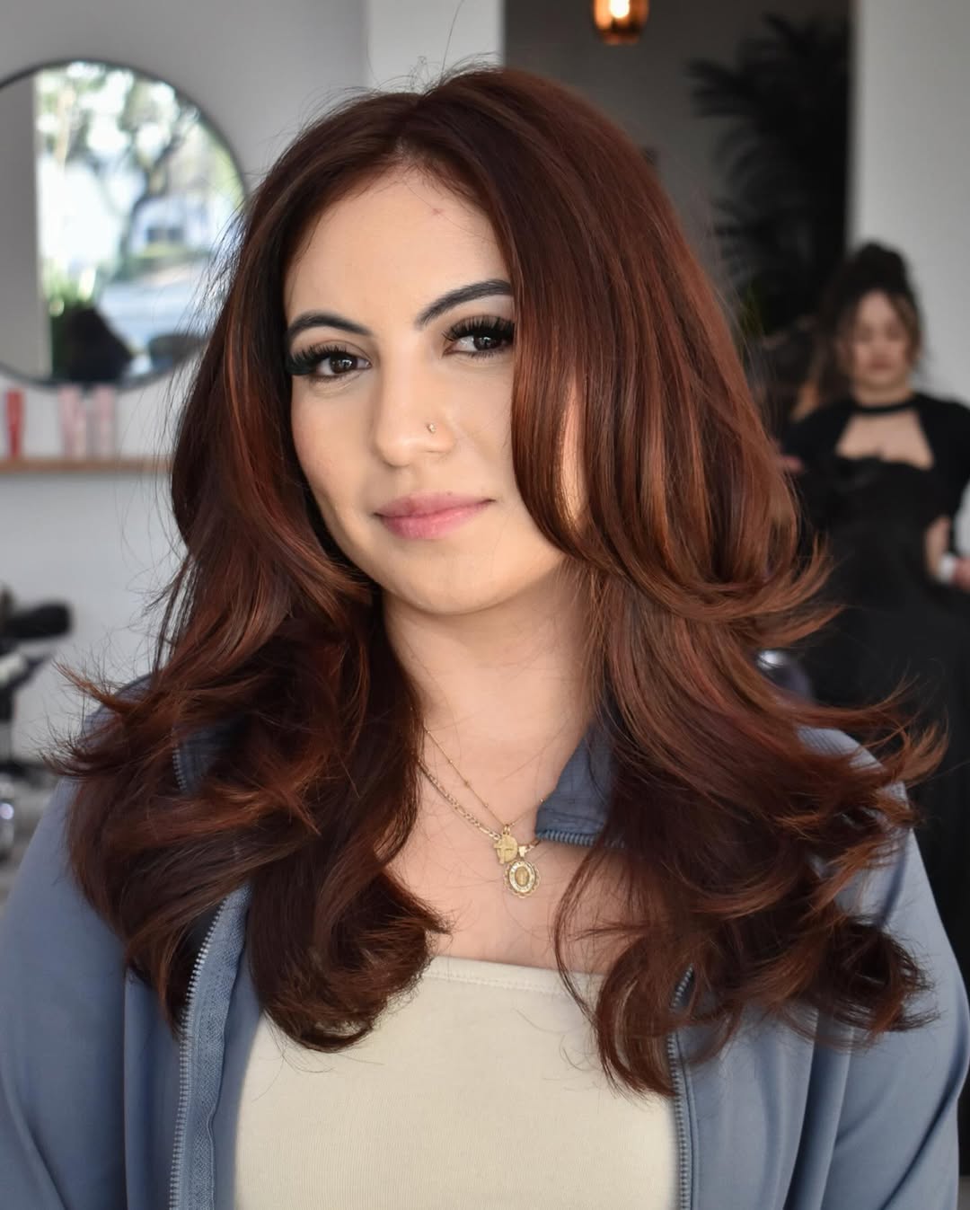 Vibrant Chestnut Curls with Subtle Highlights