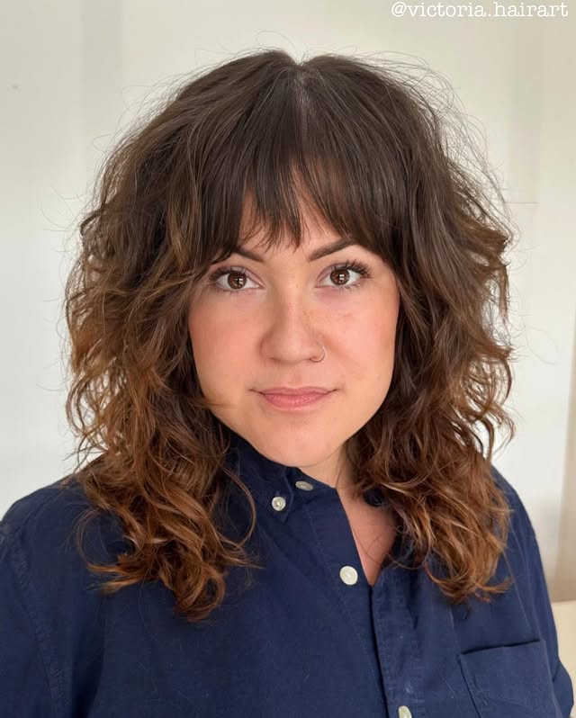 Voluminous Curly Shag with Brow-Grazing Bangs