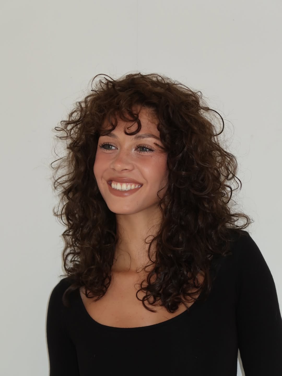 Lush Chestnut Curls with Layered Volume