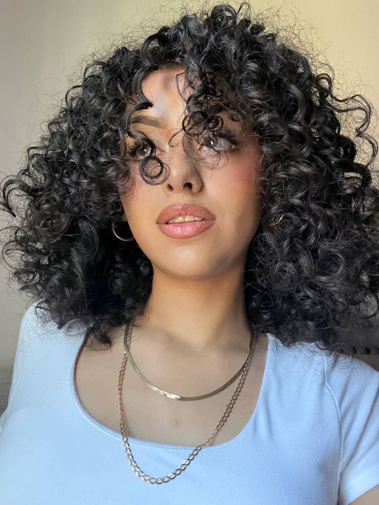 Shimmering Jet-Black Ringlets with Shoulder Sweep