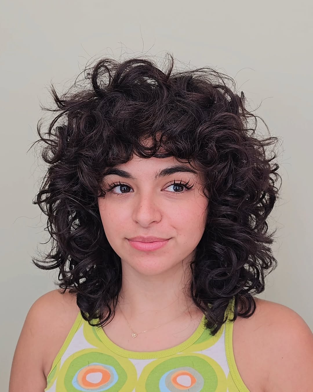 Vibrant Shoulder-Length Curly Shag with Fringe