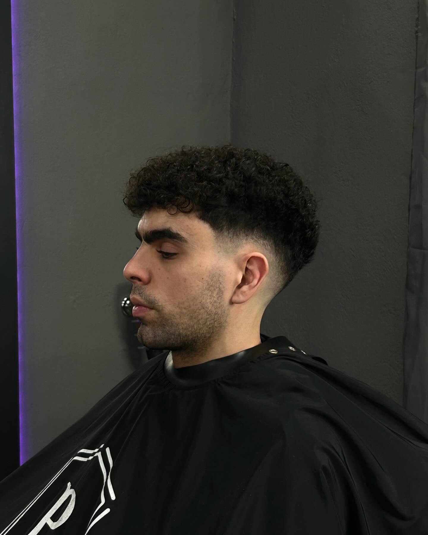 Full-Bodied Curly Top with Clean Tapered Fade