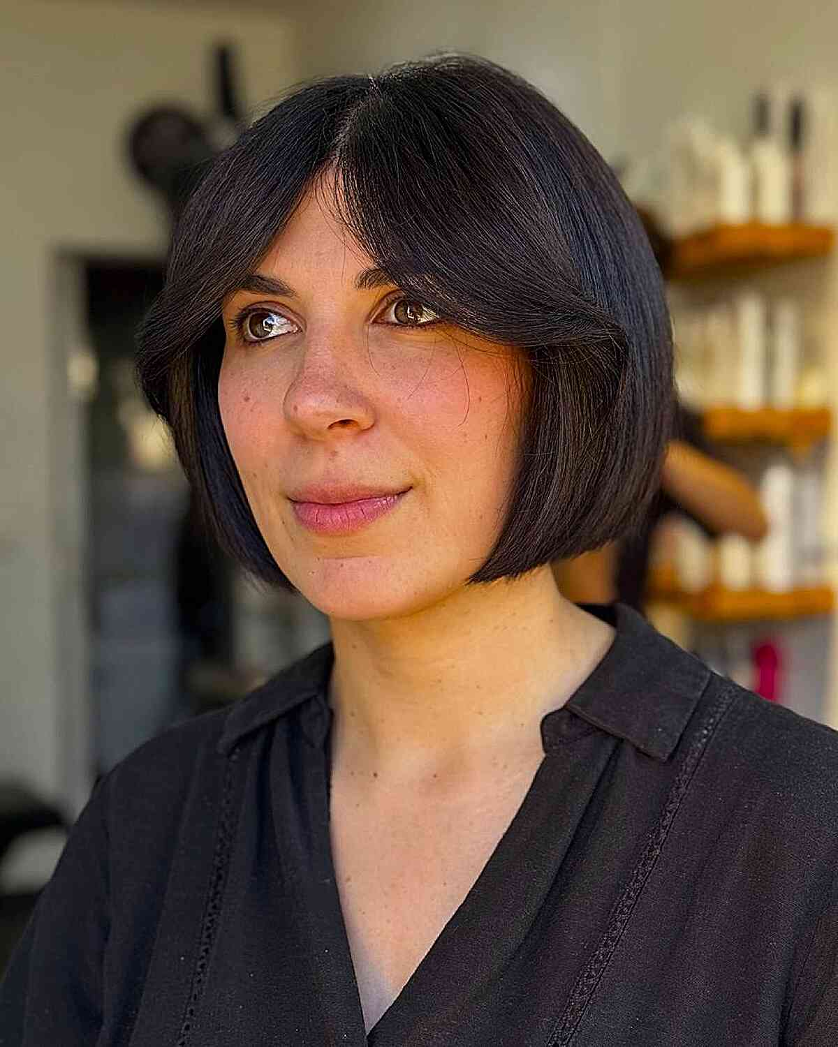 Stylish Face-Framing Curtain Bangs with a Sleek Bob