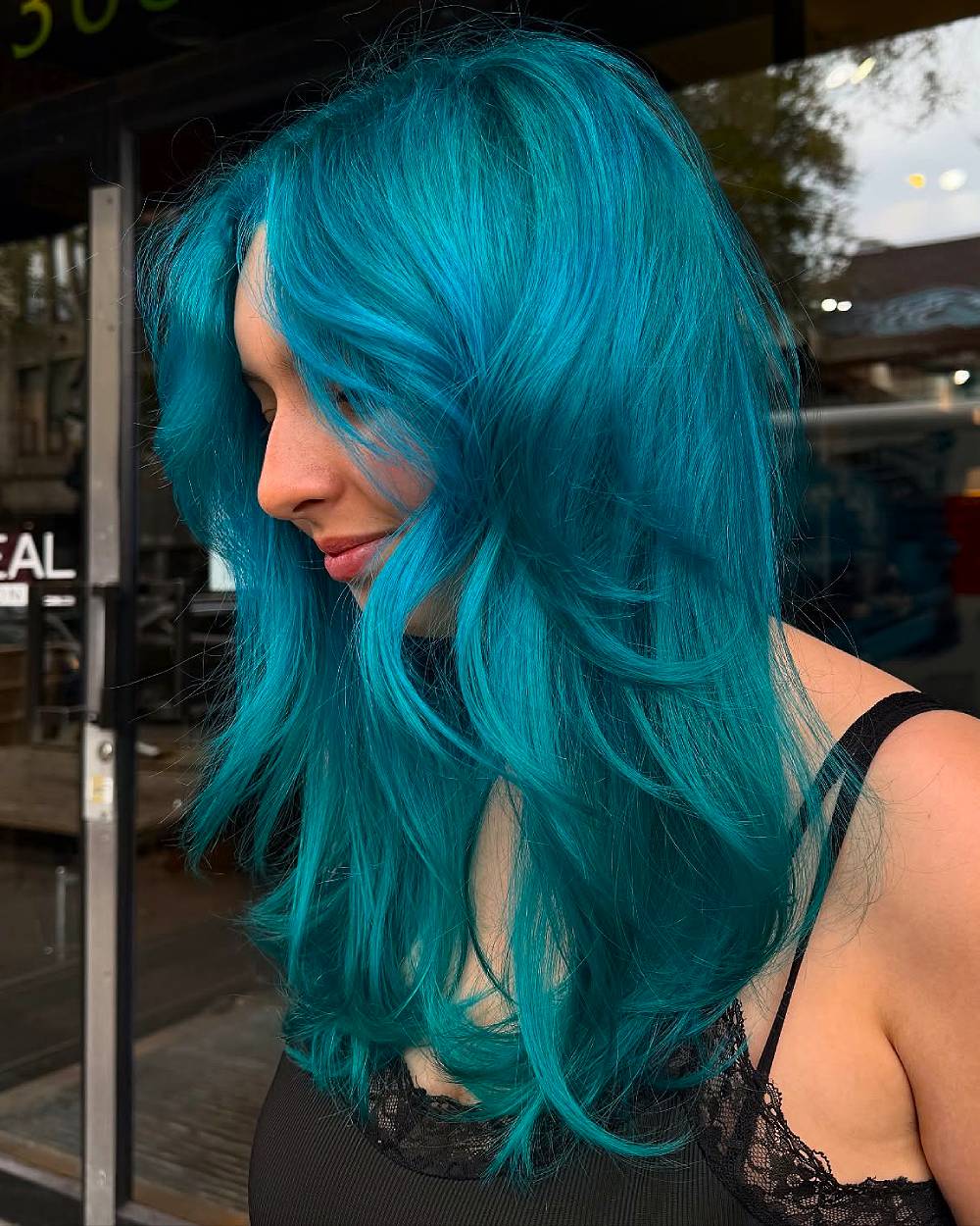 Radiant Long Layers with Bold Teal Highlights