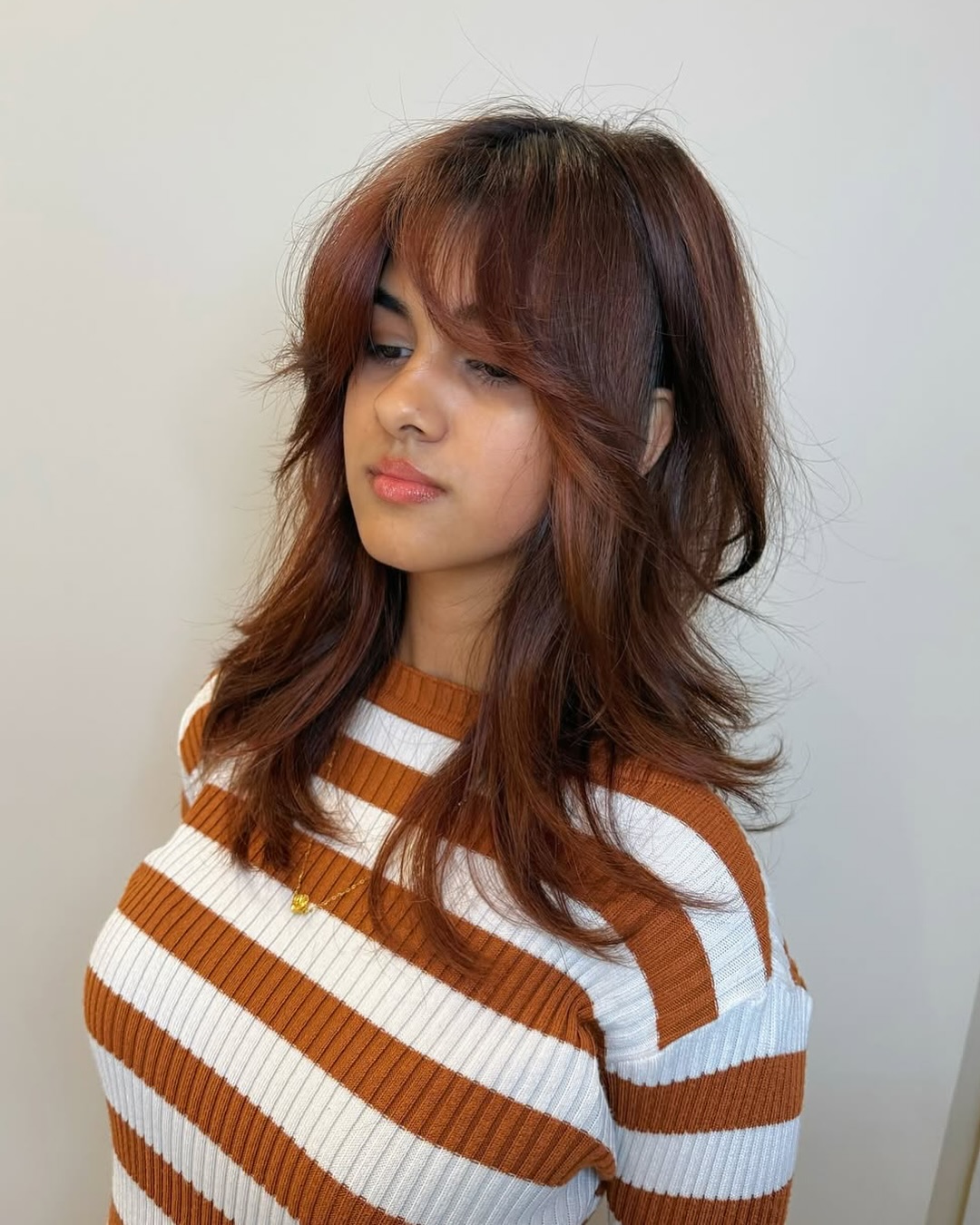 Chic Copper-Toned Feathered Bob with Soft Bangs