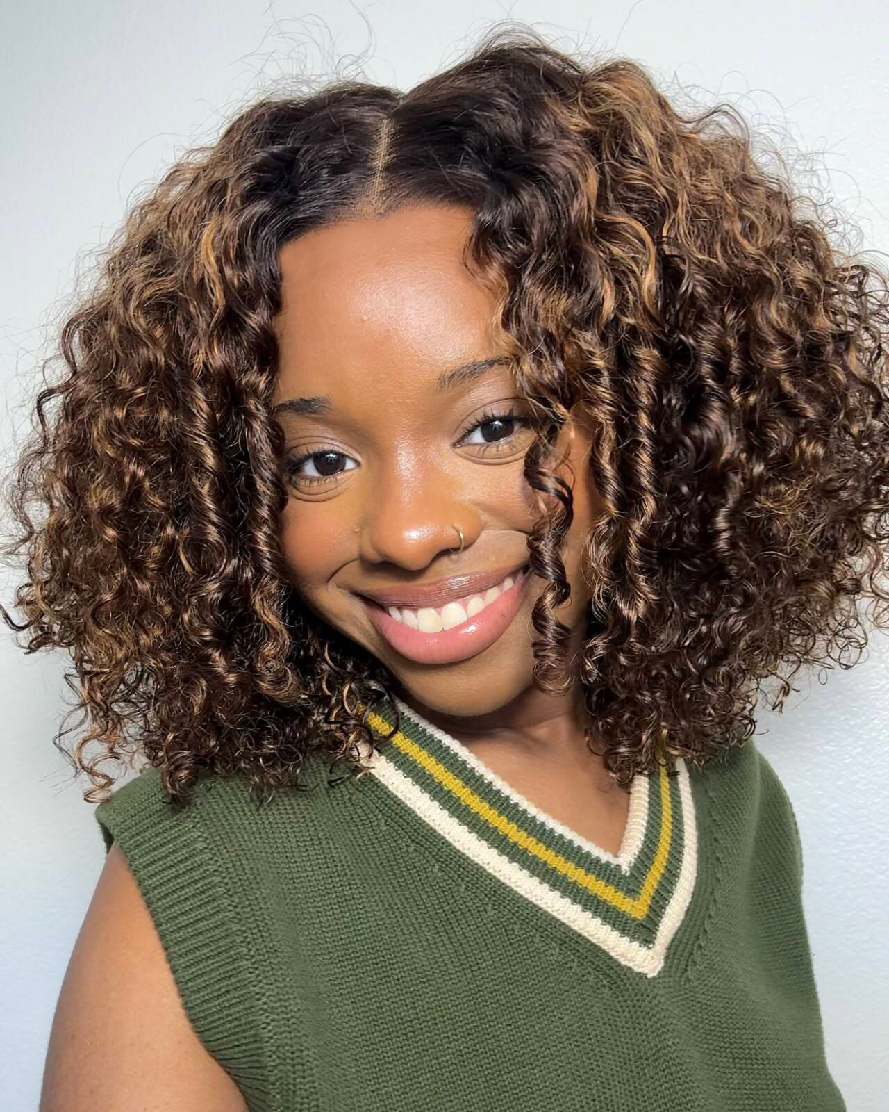 Lustrous Chest-Length Spiral Curls with Golden Highlights