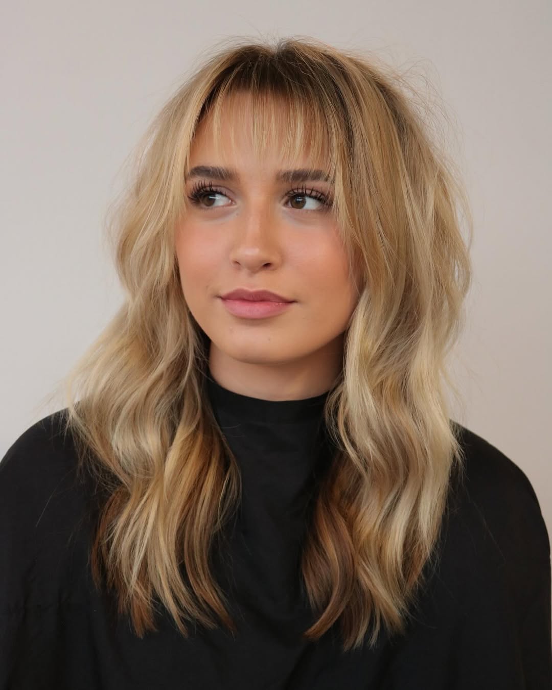 Whimsical Blonde Waves with Feathered Wispy Bangs