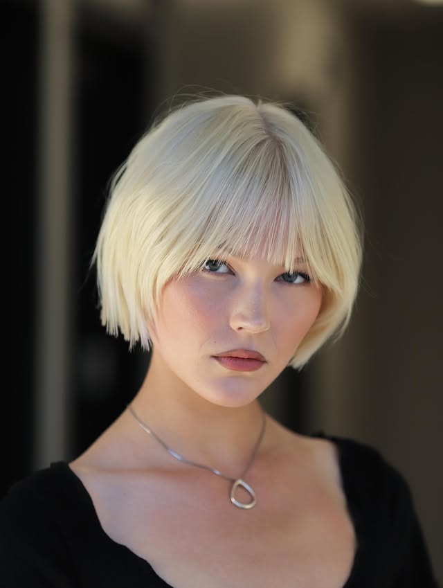 Platinum Blonde Blunt Cut Bob with Feathered Bangs