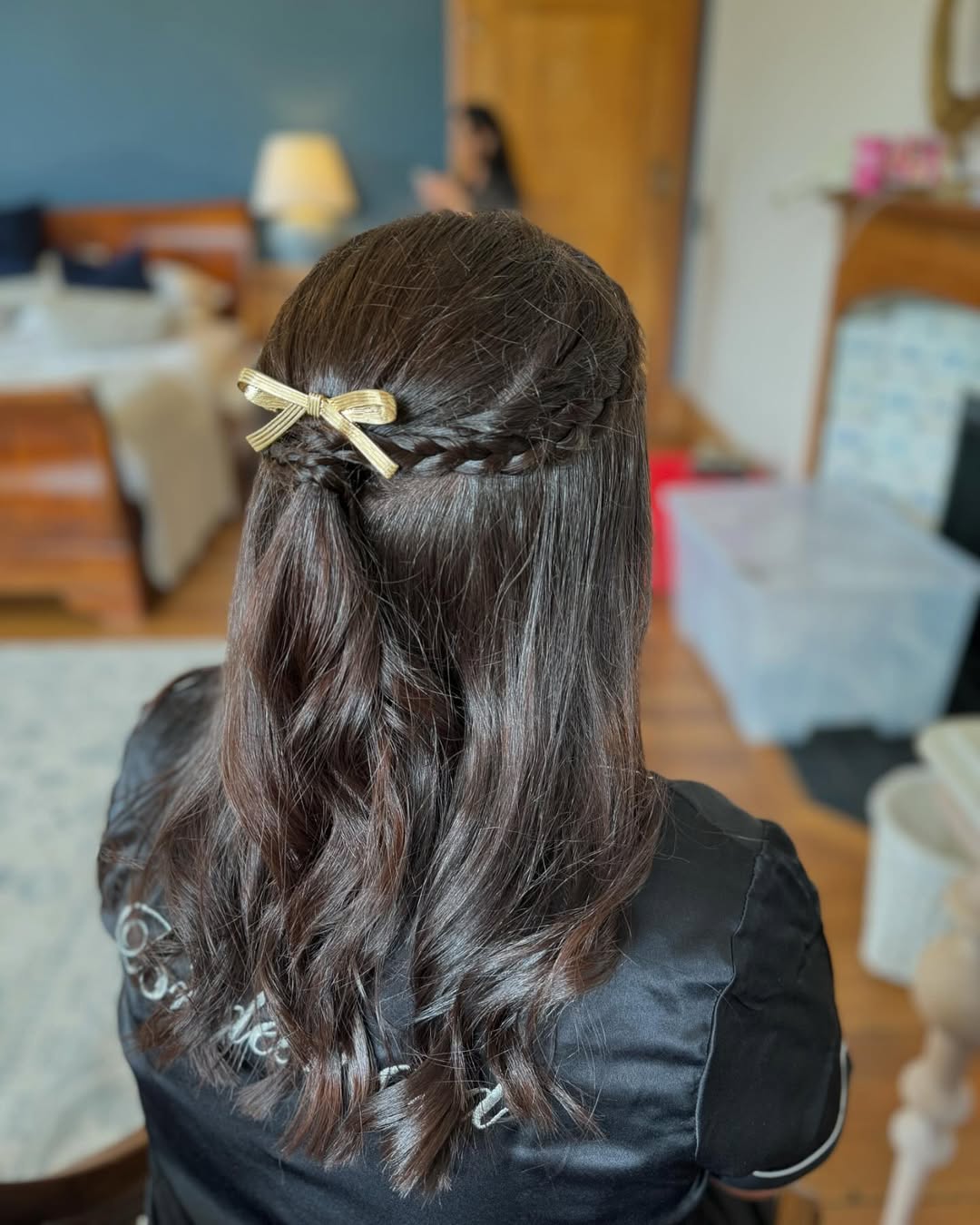 Penteado elegante com tranças e meio preso, com presilha dourada.