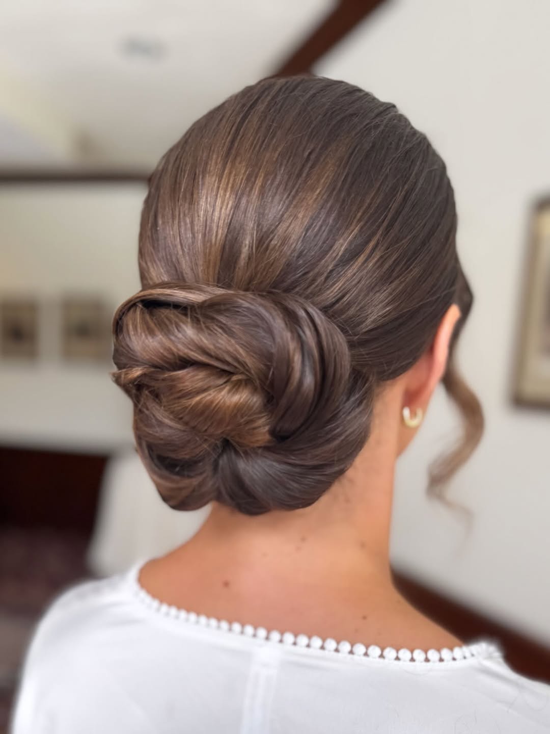 Um deslumbrante coque baixo clássico para a elegância da noiva.