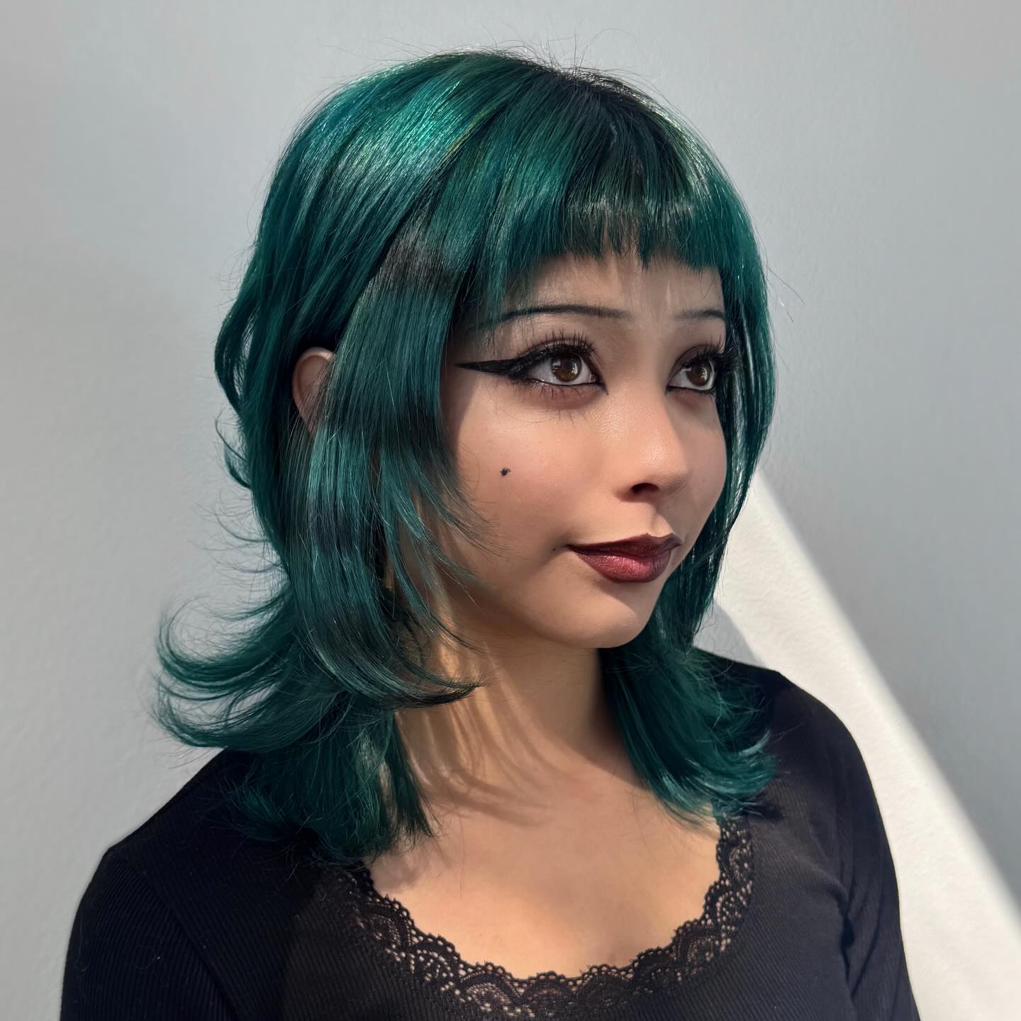Edgy Teal Bob with Feathered Bangs