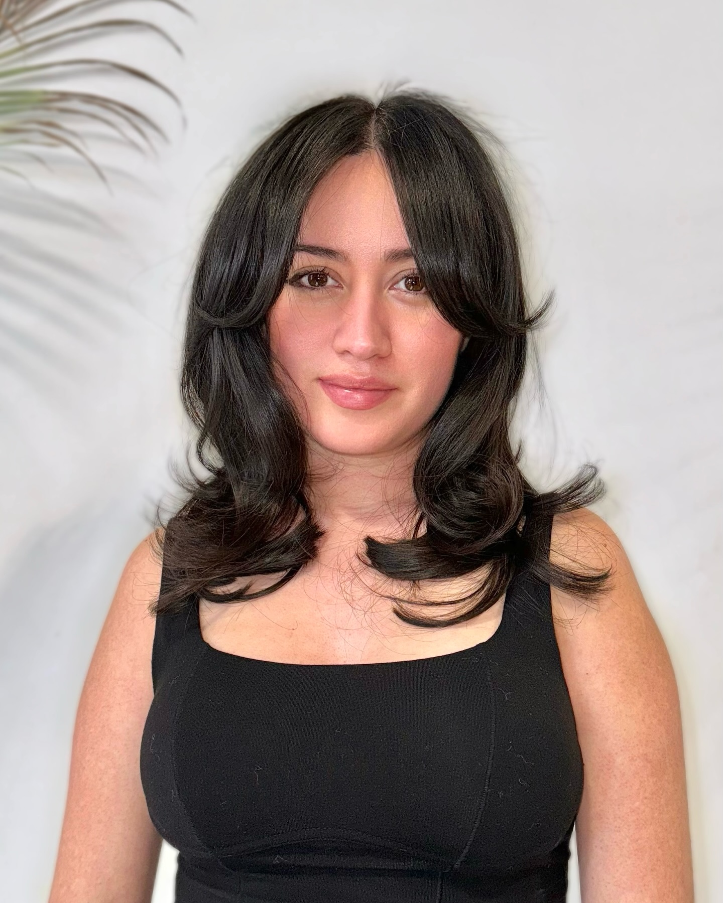 Flowing Black Layers with Soft Curtain Bangs