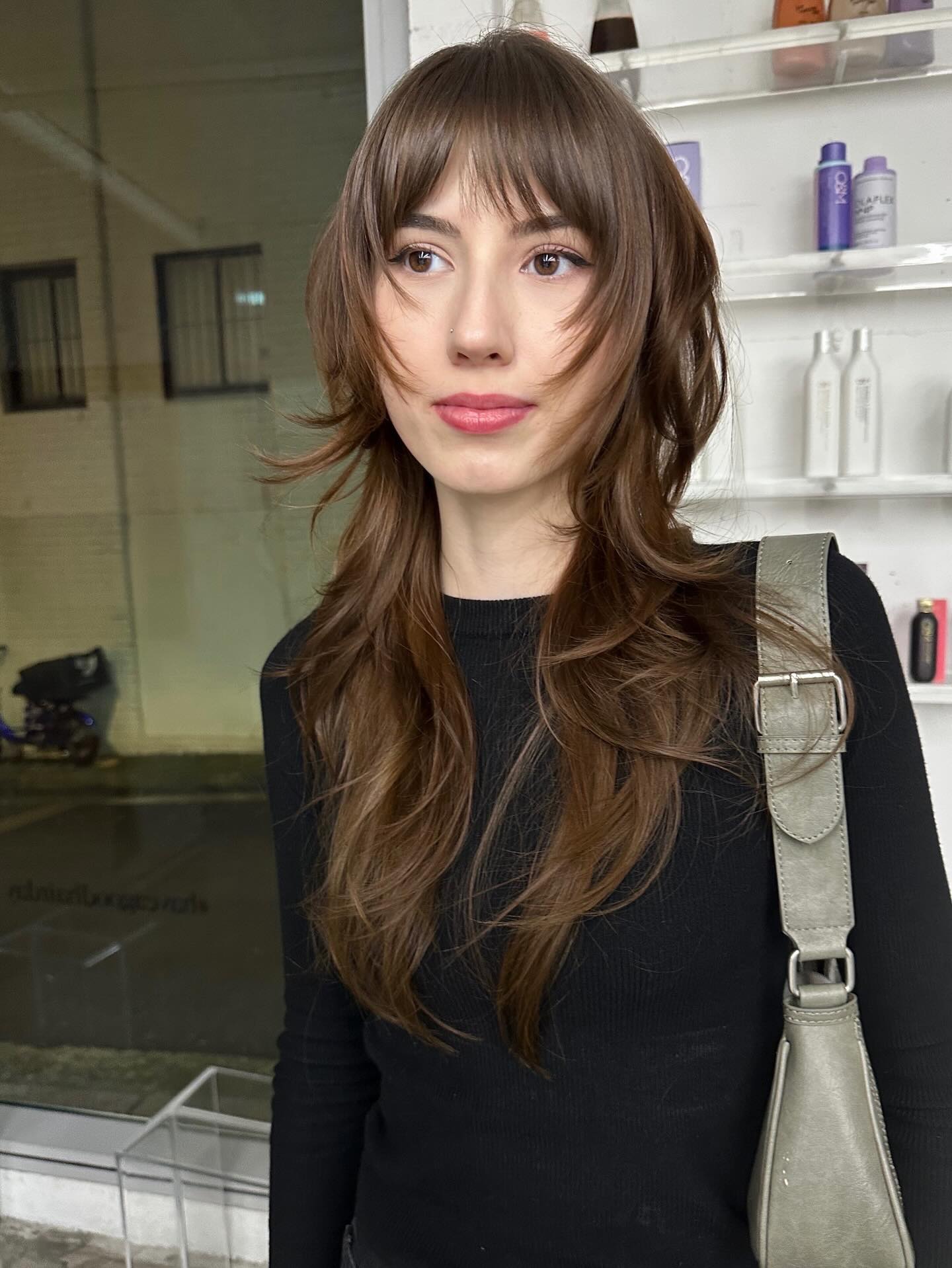 Playful Chestnut Waves with Wispy Bangs