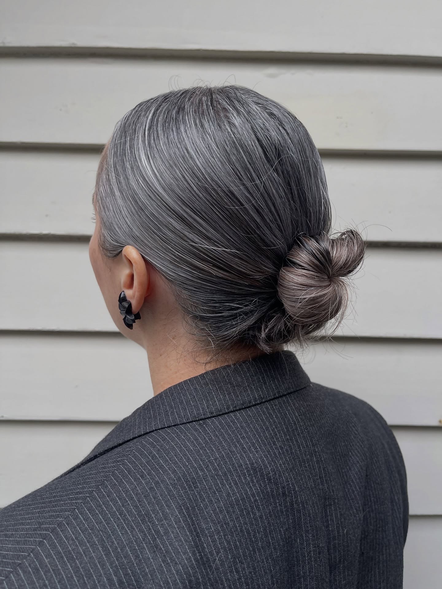 Sleek Silver Low Bun with Natural Highlights