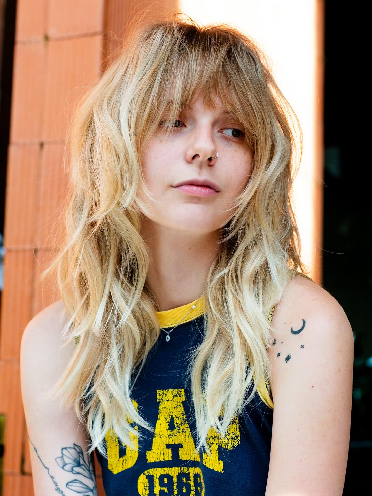 Sun-Kissed Blonde Tousled Layers with Curtain Bangs