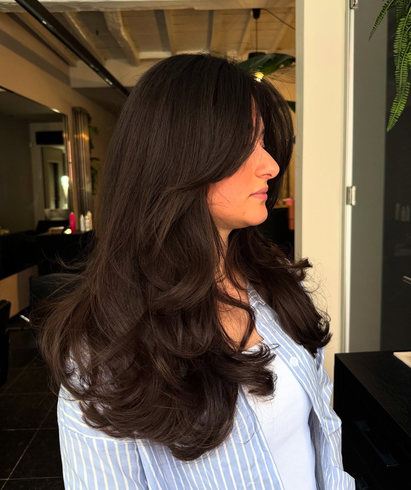 Captivating Chestnut Curls with Subtle Layers