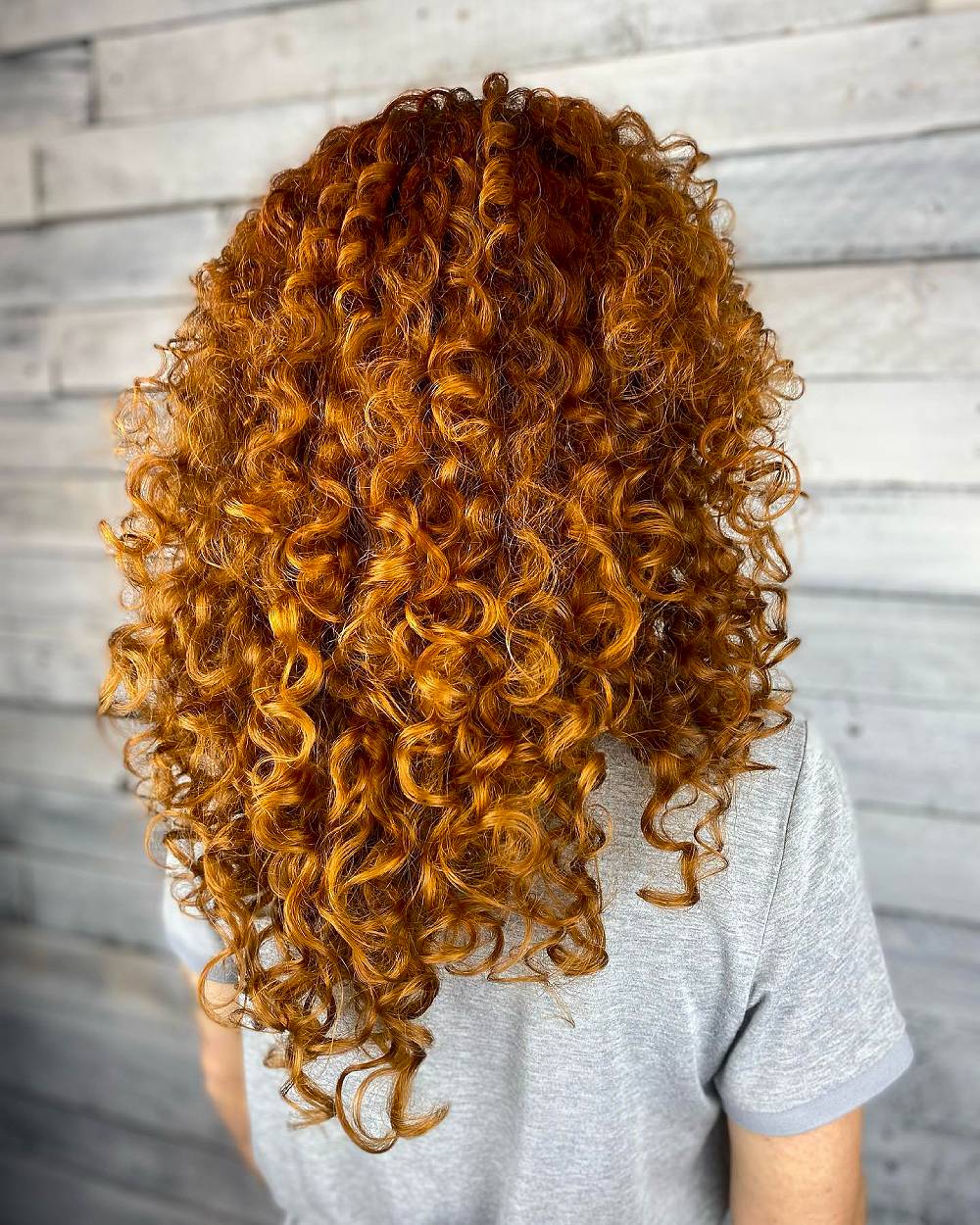 Radiant Curly Layers with Rich Sunset Tones