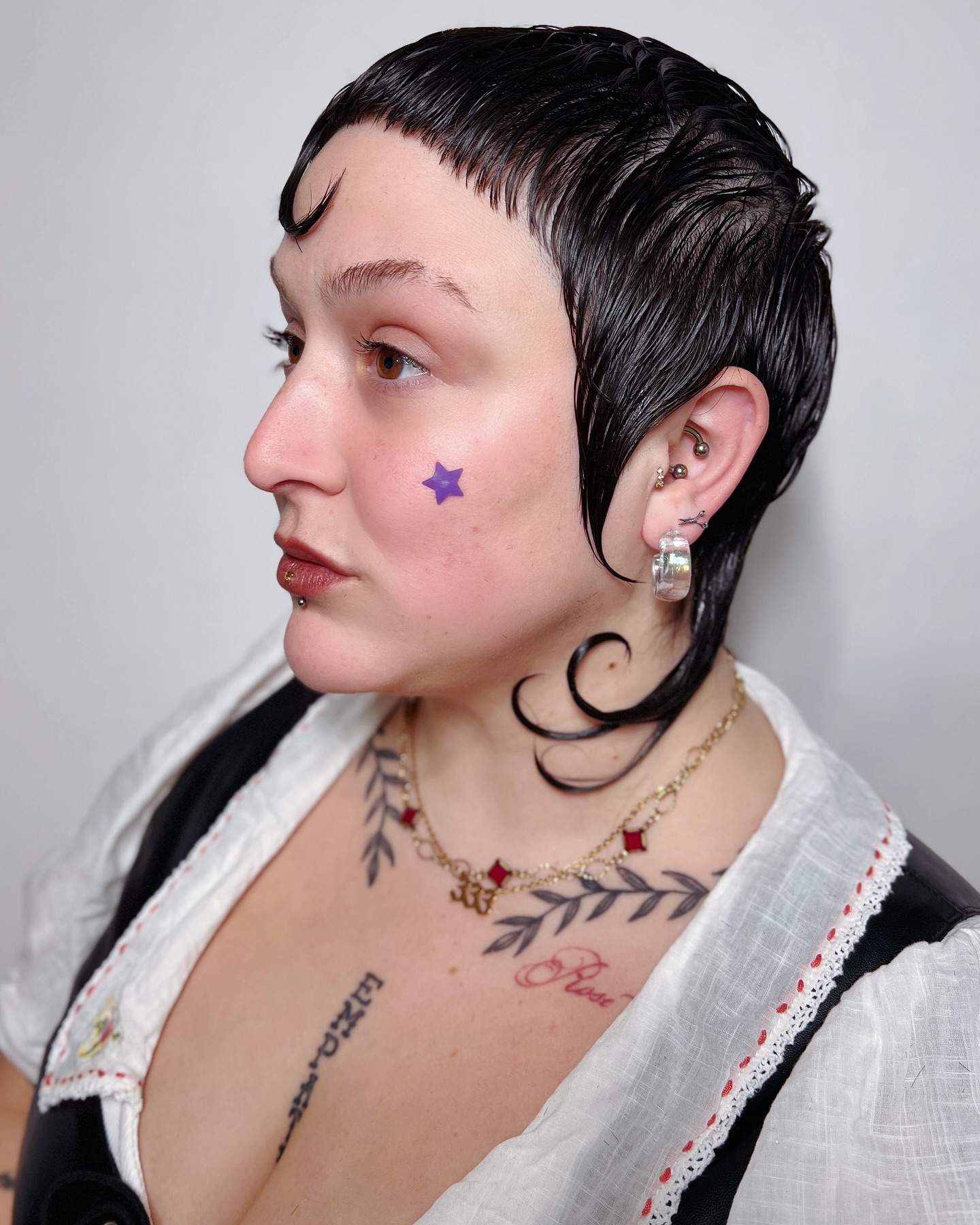 Edgy Black Wet Pixie Cut with Side-Swept Bangs