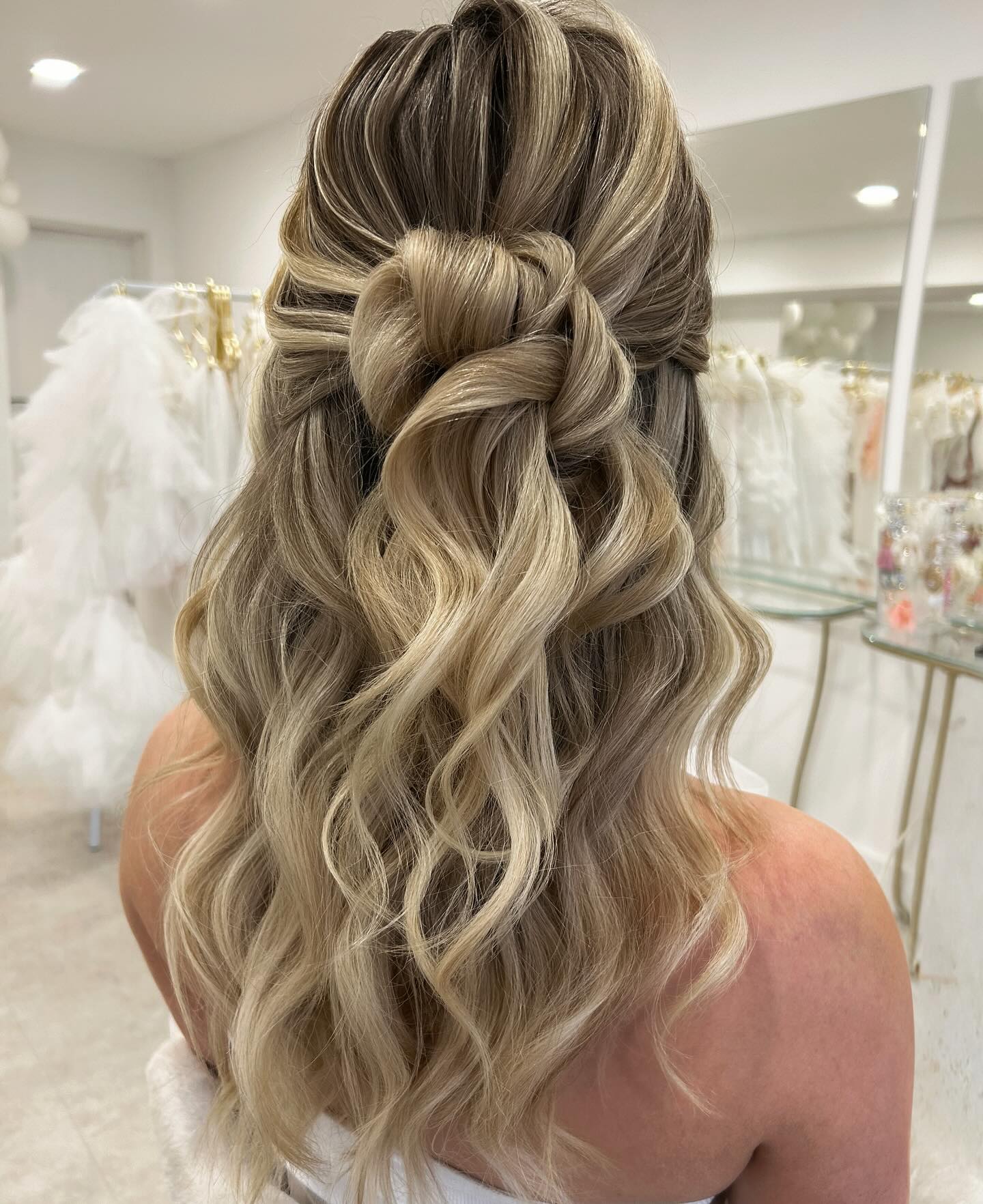 Elegant Loose Curls with Braided Half-Up Knot