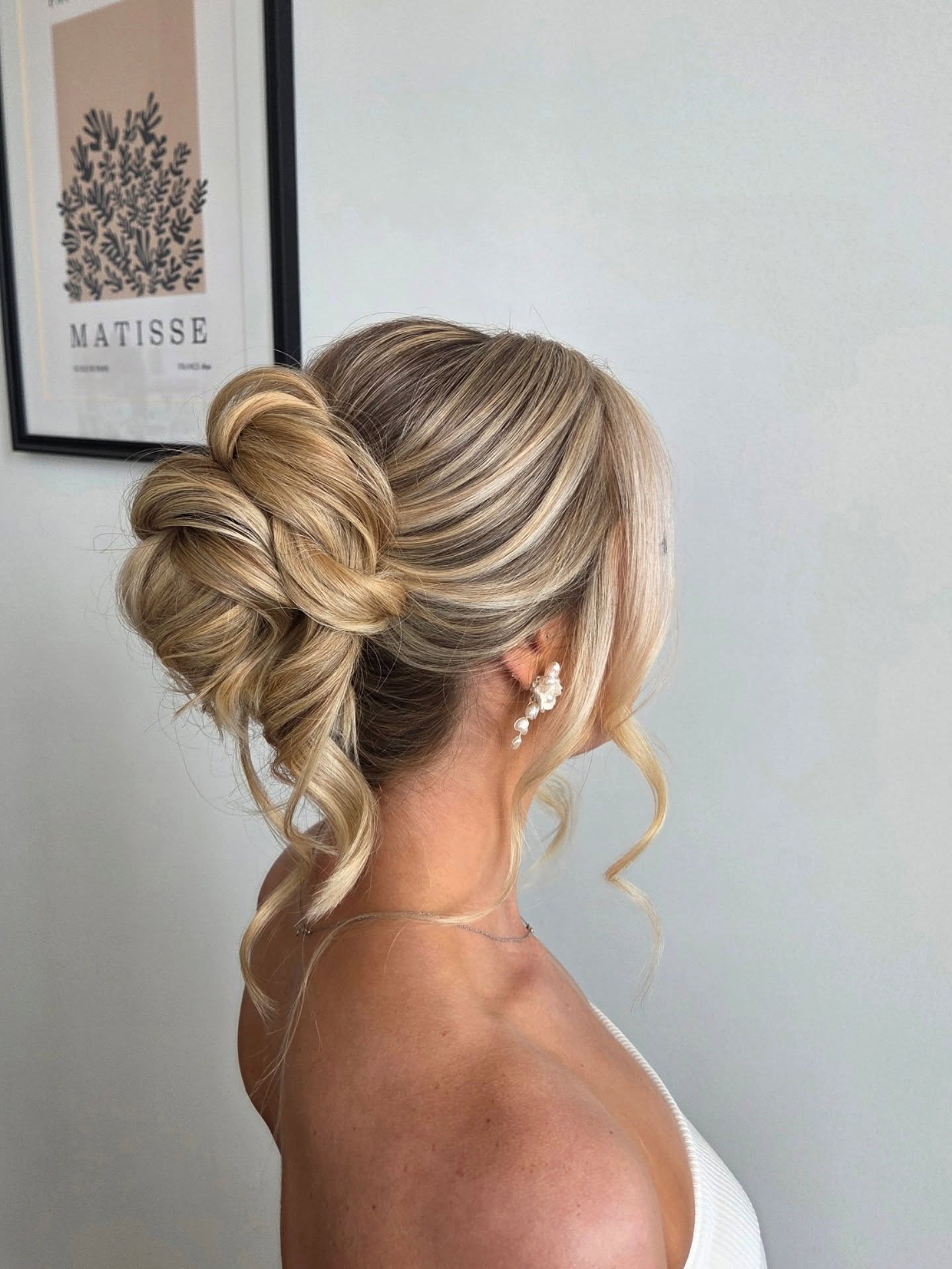 Delicate Blonde Swept-Up Twist with Loose Curls
