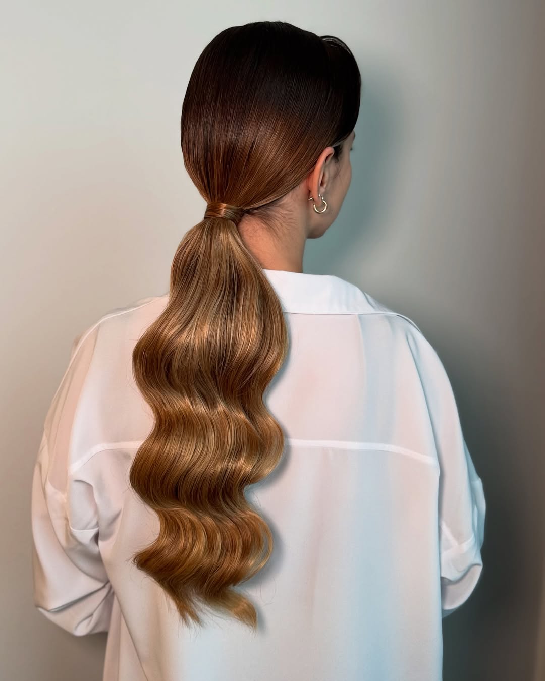 Sleek Ponytail with Cascading Golden Waves