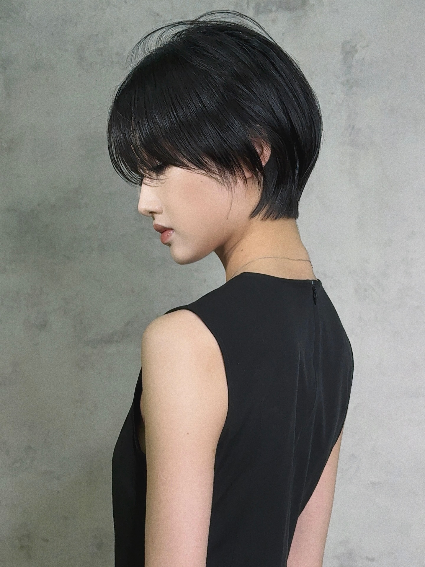 Elegant Short Black Layered Bob with Side-Swept Bangs