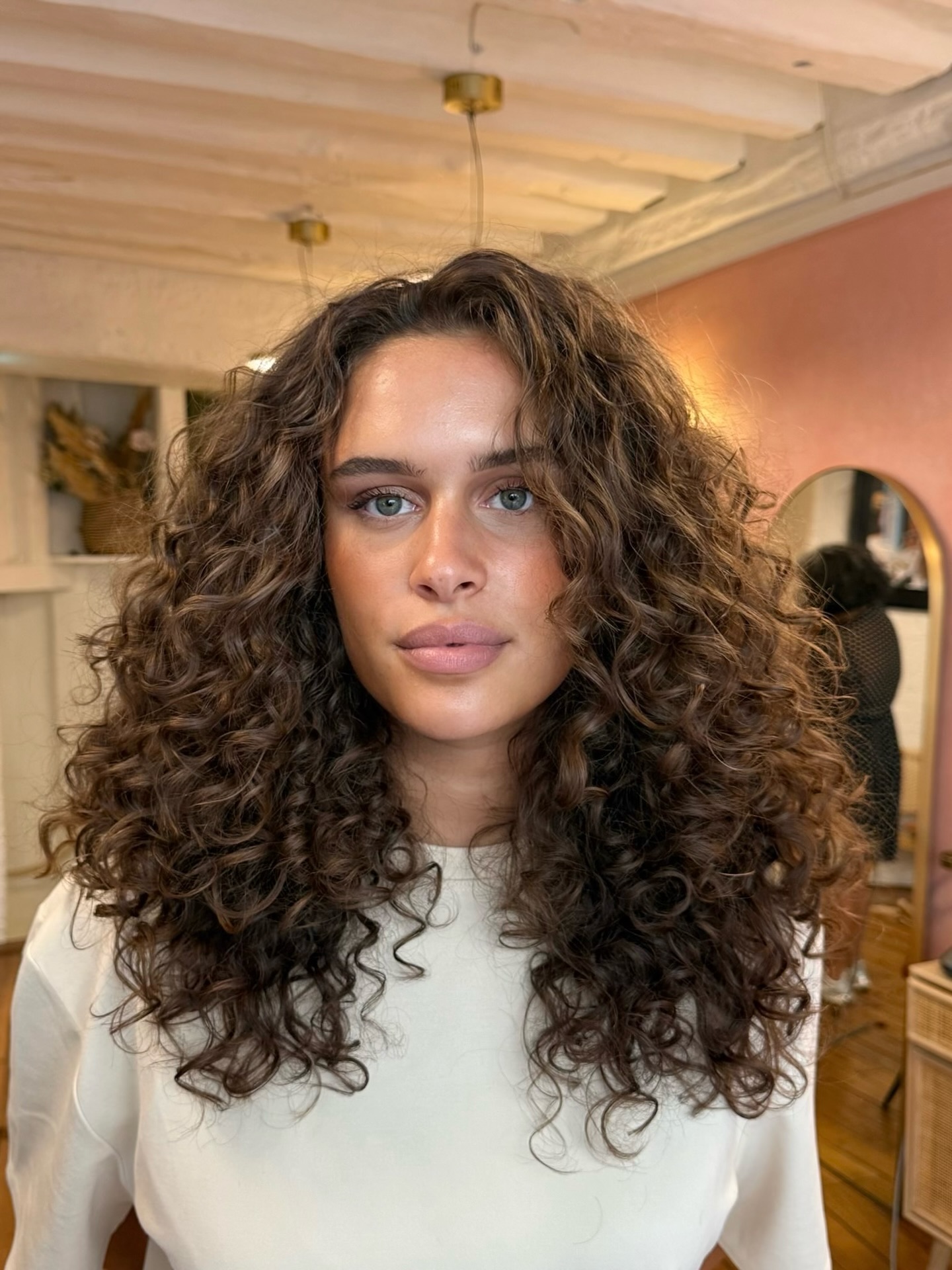 Lush Chestnut Textured Curls with Soft Highlights