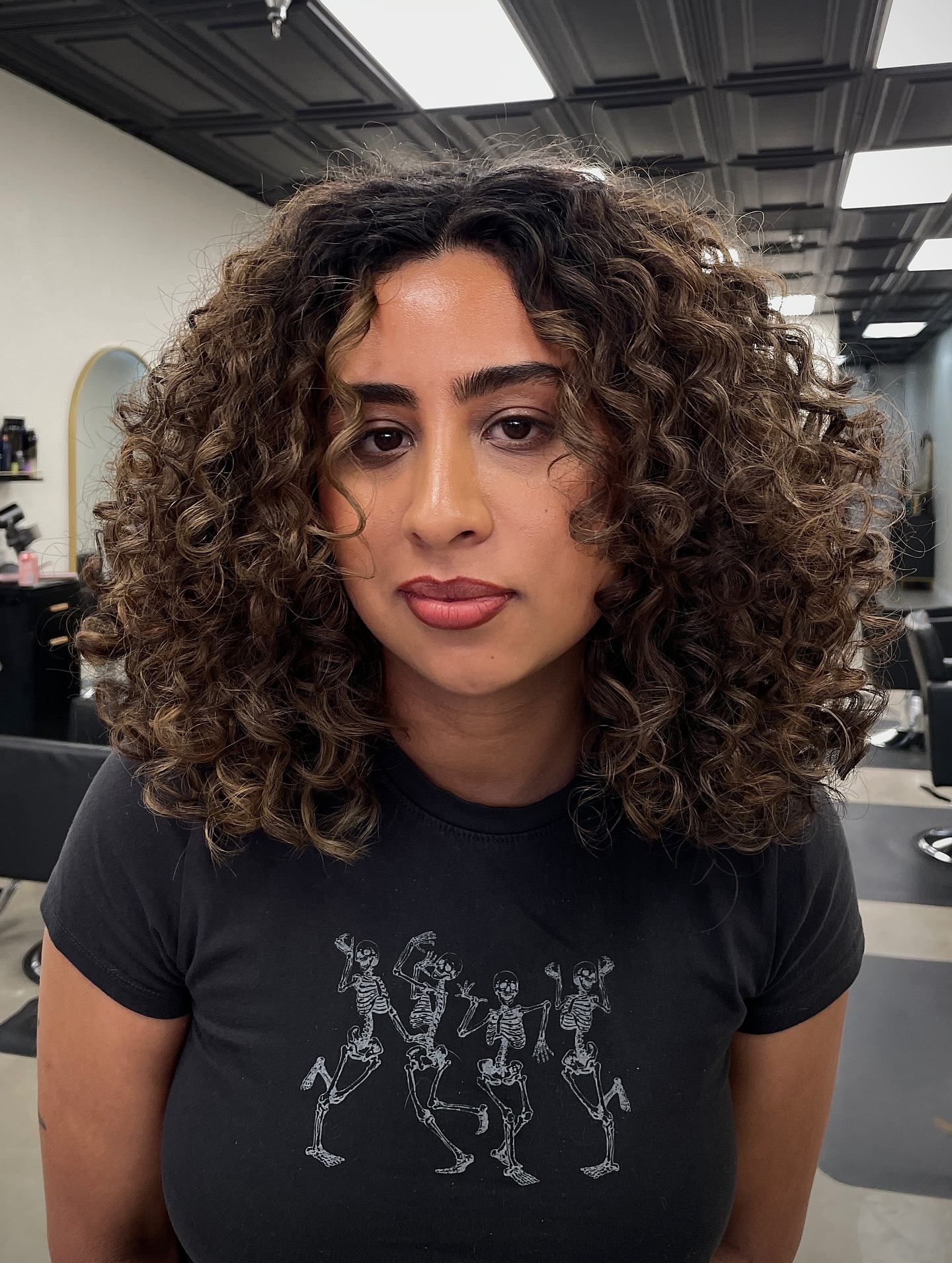 Rich Caramel Curls with a Soft Mid-Length Cut