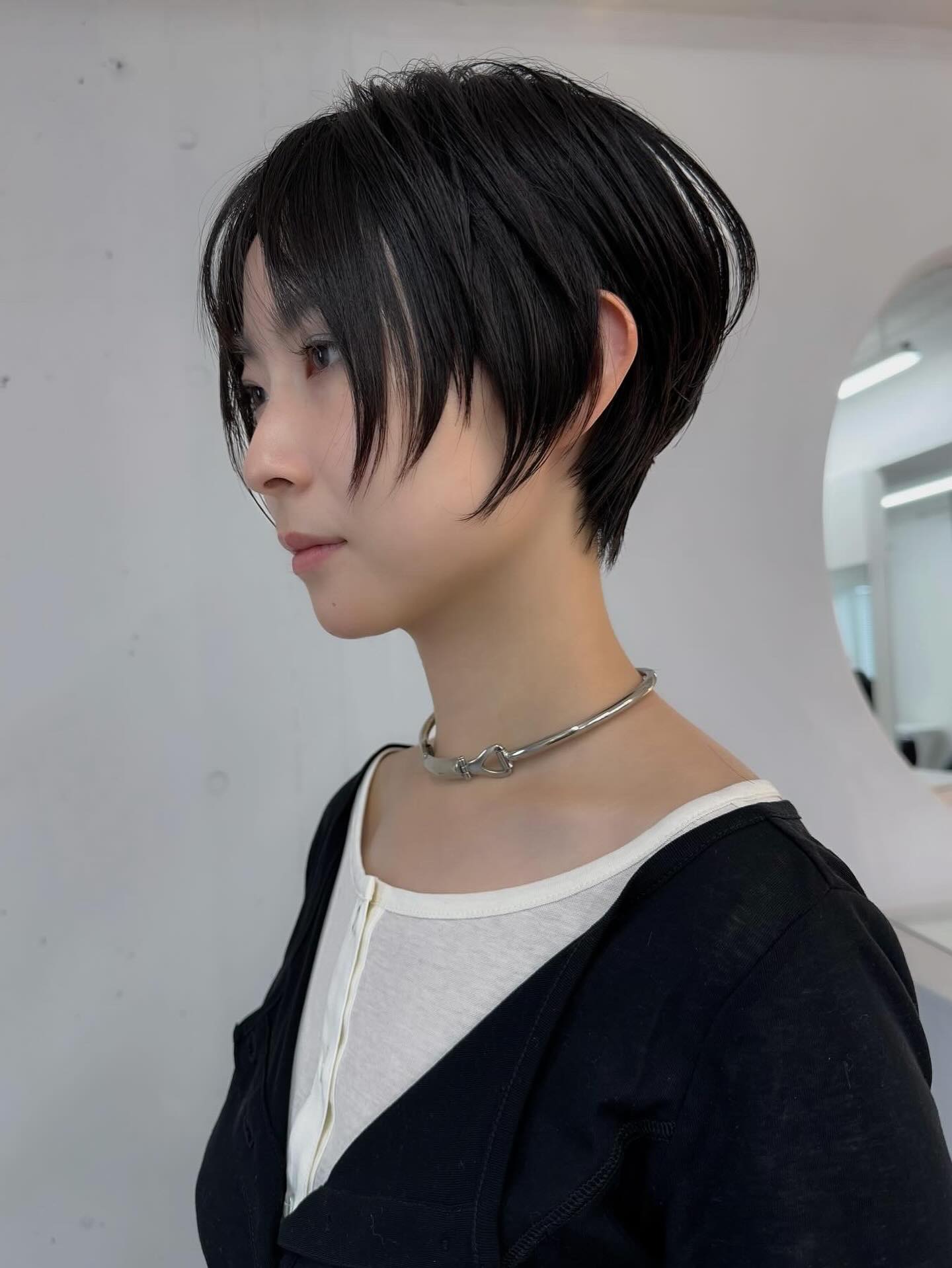 Sharp Jet-Black Tousled Pixie with Long Bangs
